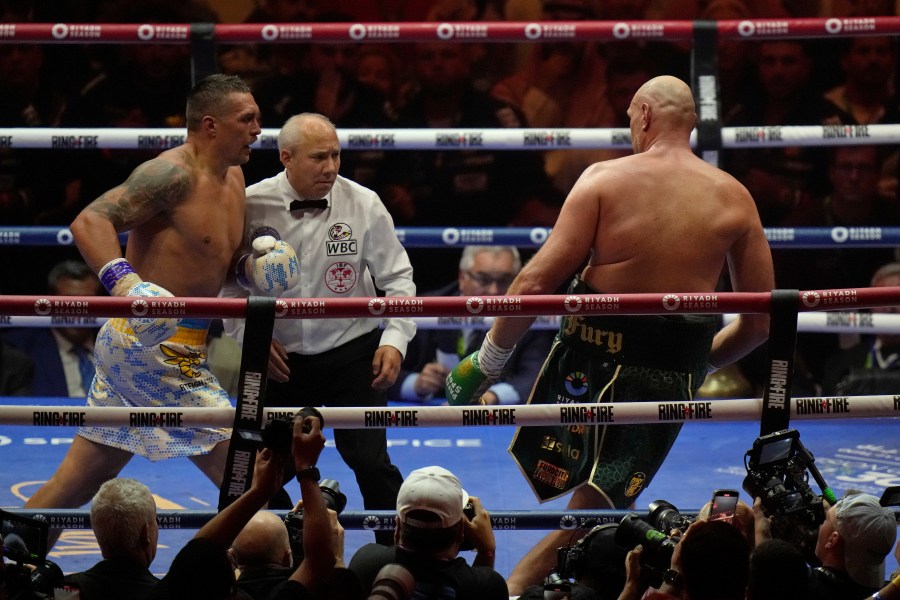 Ukraine's Oleksandr Usyk, left, pursues Britain's Tyson Fury during their undisputed heavyweight world championship boxing fight at the Kingdom Arena in Riyadh, Saudi Arabia, Sunday, May 19, 2024. (AP Photo/Francisco Seco)