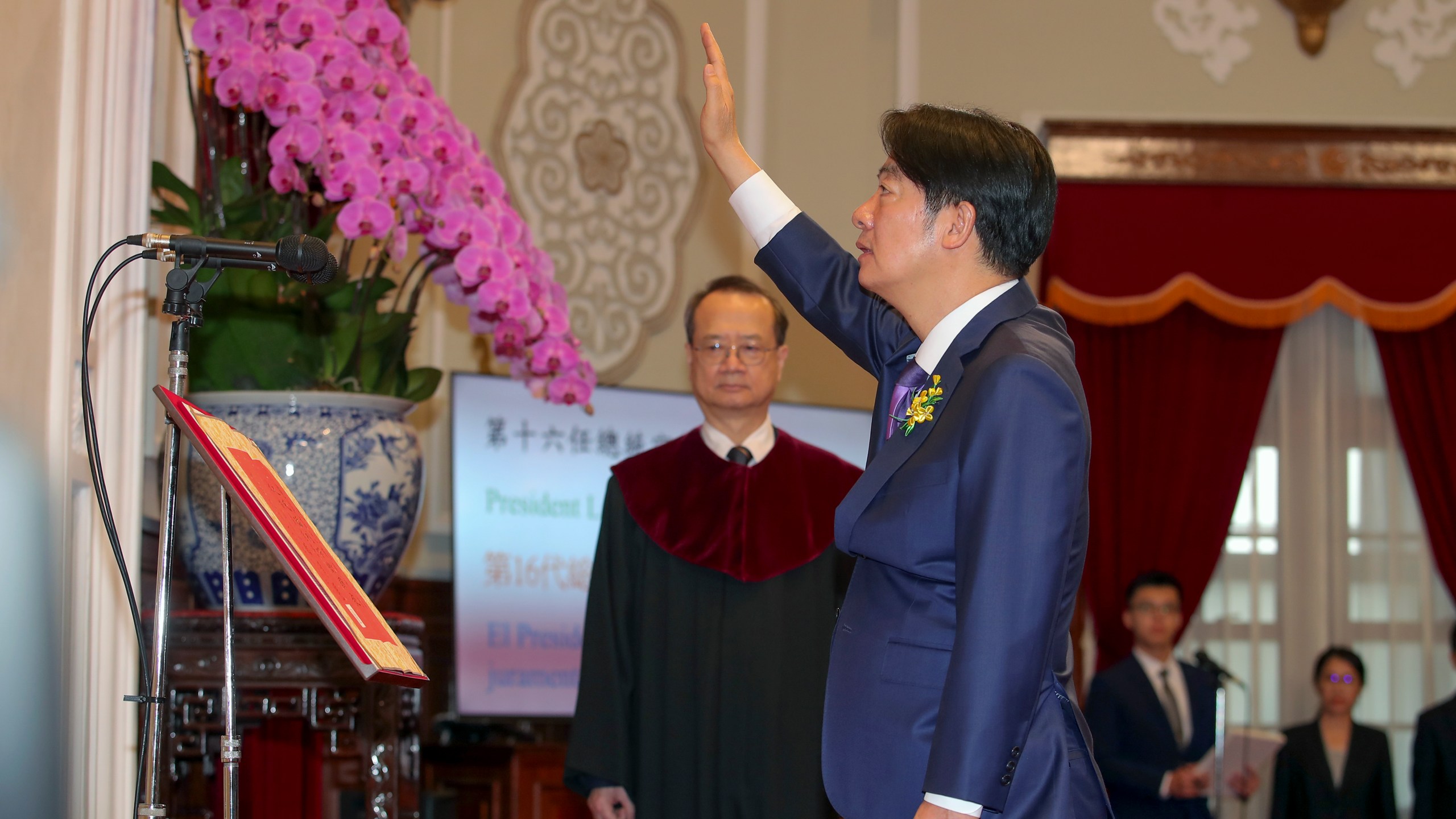 In this photo released by the Taipei News Photographer, President-elect Lai Ching-te, also known by his English name William, gets sworn in as Taiwan's new president during his inauguration ceremony in Taipei, Taiwan, Monday, May 20, 2024. Lai was sworn in as Taiwan's new president Monday, beginning a term in which he is expected to continue the self-governing island's policy of de facto independence from China while seeking to bolster its defenses against Beijing. (Taipei News Photographer via AP)