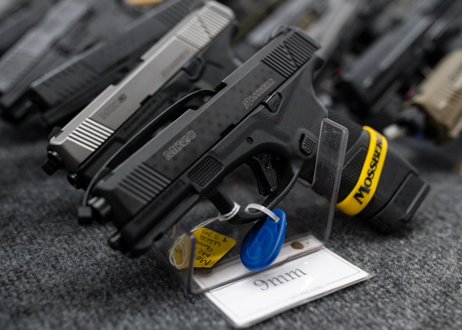 FILE - Pistols sit on display during the first day of the Silver Spur Gun and Blade Show, Jan. 22, 2022, in Odessa, Texas. On Monday, May 20, 2024, a federal judge blocked the Biden administration from enforcing a new rule in Texas that would require firearms dealers to run background checks on buyers at gun shows or other places outside brick-and-mortar stores. (Eli Hartman/Odessa American via AP, File)