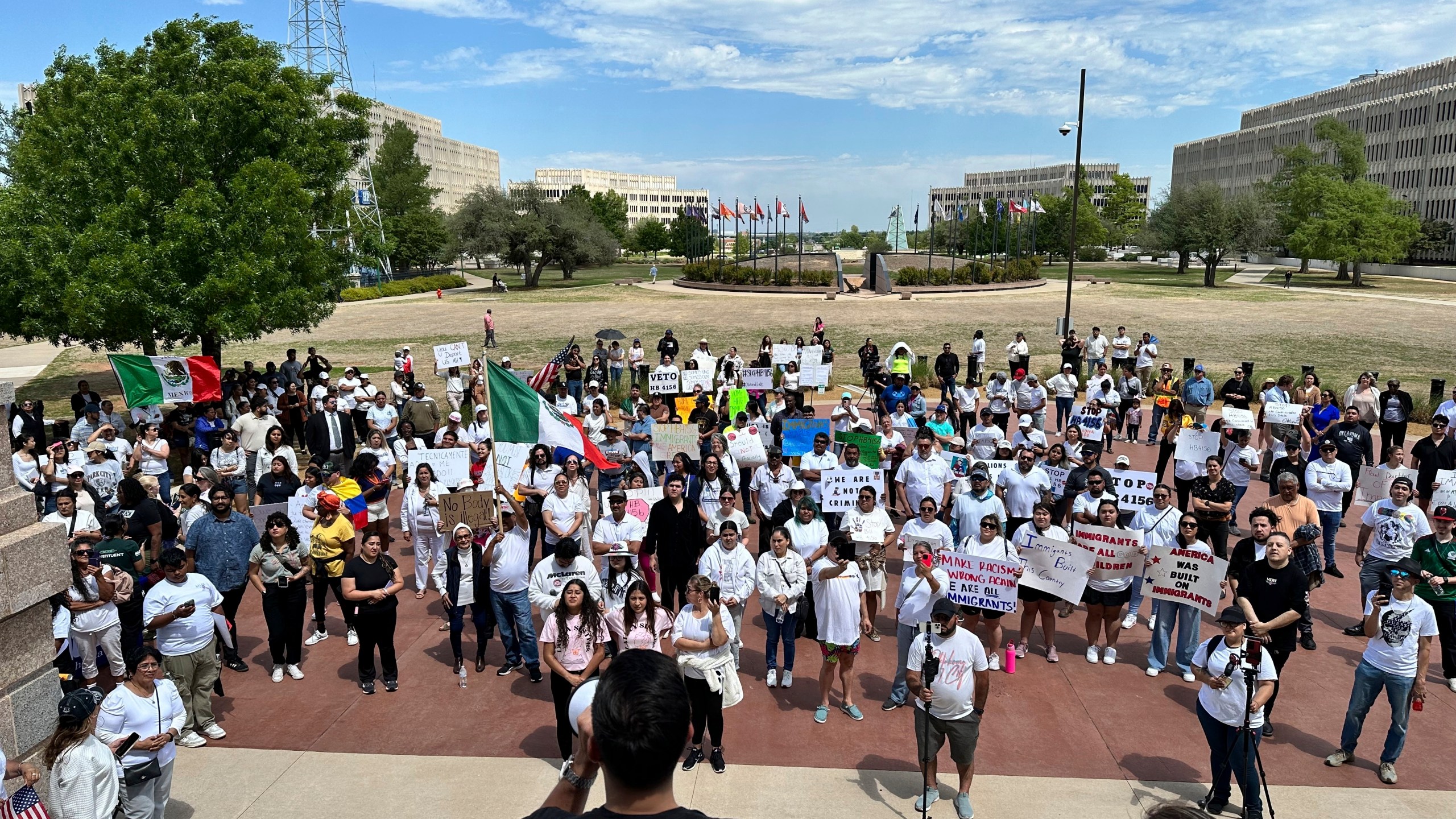 Oklahoma City immigration attorney Sam Wargin Grimaldo speaks to a group outside the Oklahoma Capitol on Tuesday, April 23, 2024, who opposed a bill that would impose criminal penalties to be in the state illegally. Oklahoma is one of several GOP-led states seeking to give broader immigration enforcement powers to local police. (AP Photo/Sean Murphy)