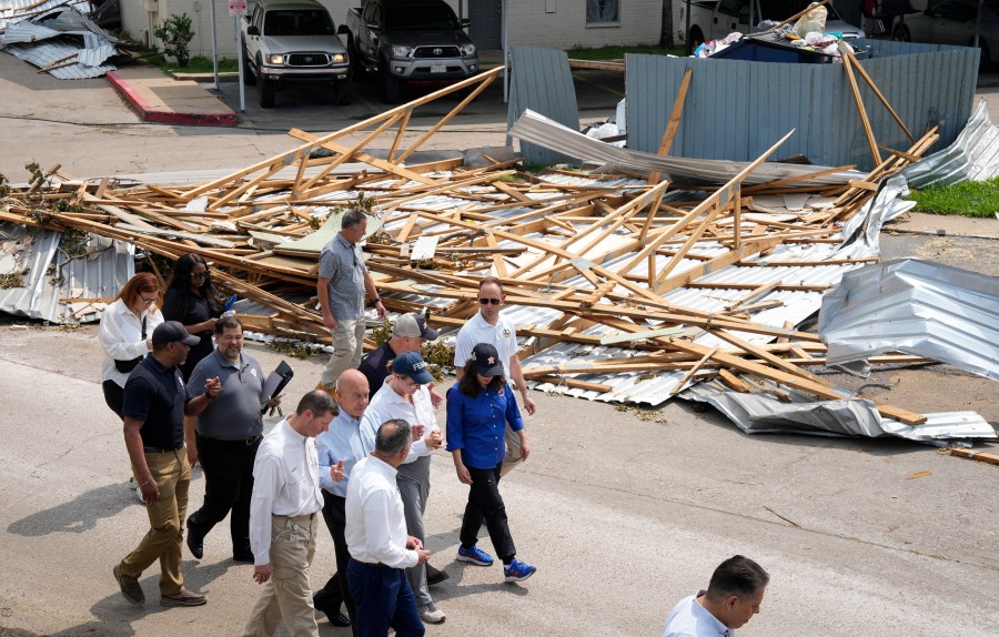 FEMA Administrator Deanne Criswell, blue FEMA hat, visits an apartment complex damaged by severe storms with Houston Mayor John Whitmire, to her right, and Harris County Precinct 4 Commissioner Lesley Briones, to her left, Tuesday, May 21, 2024, at Spring Branch in Houston. (Yi-Chin Lee/Houston Chronicle via AP)