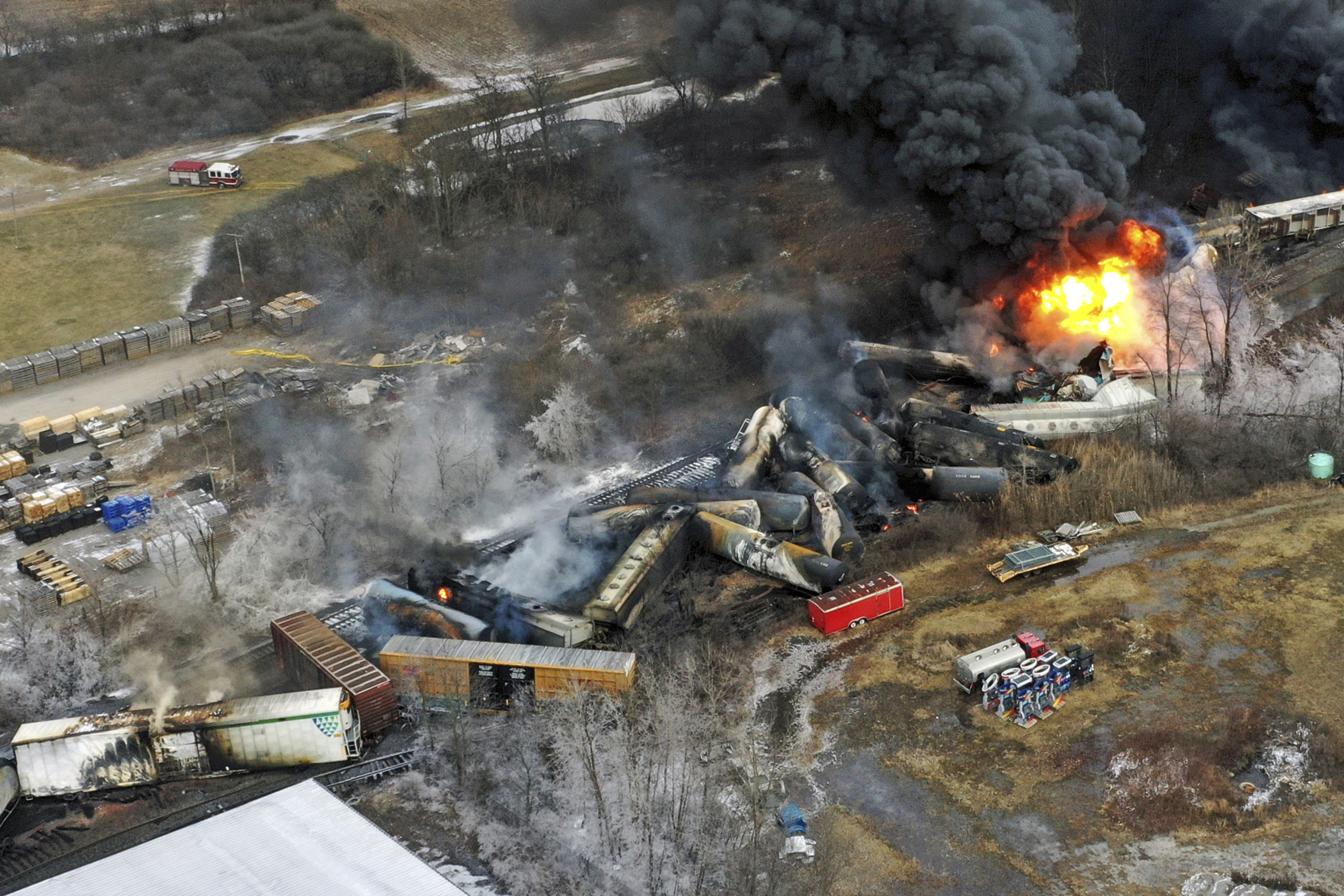 Debris from the train crash in East Palestine, Ohio, lies scattered and burning.