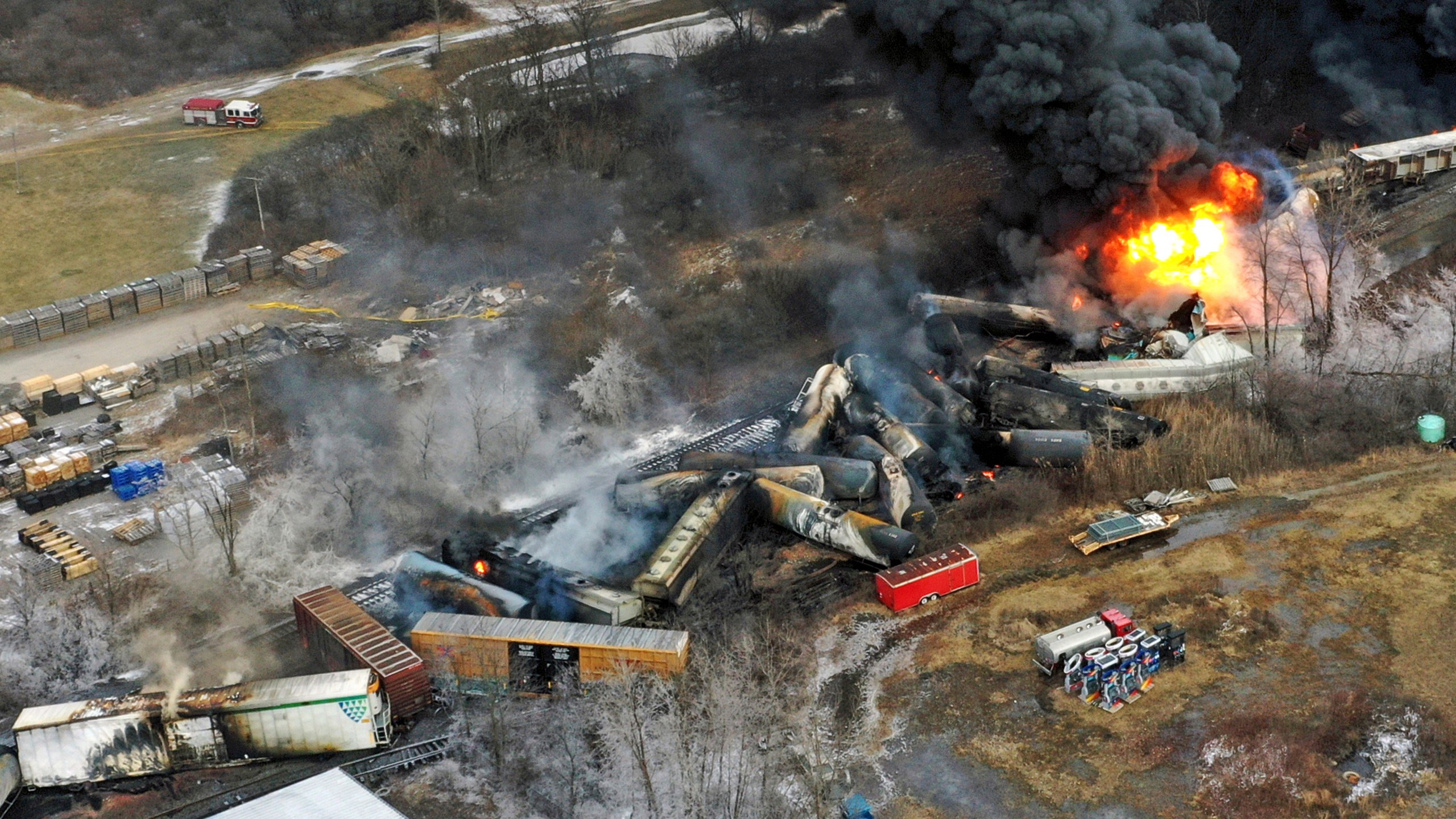 Debris from the train crash in East Palestine, Ohio, lies scattered and burning.