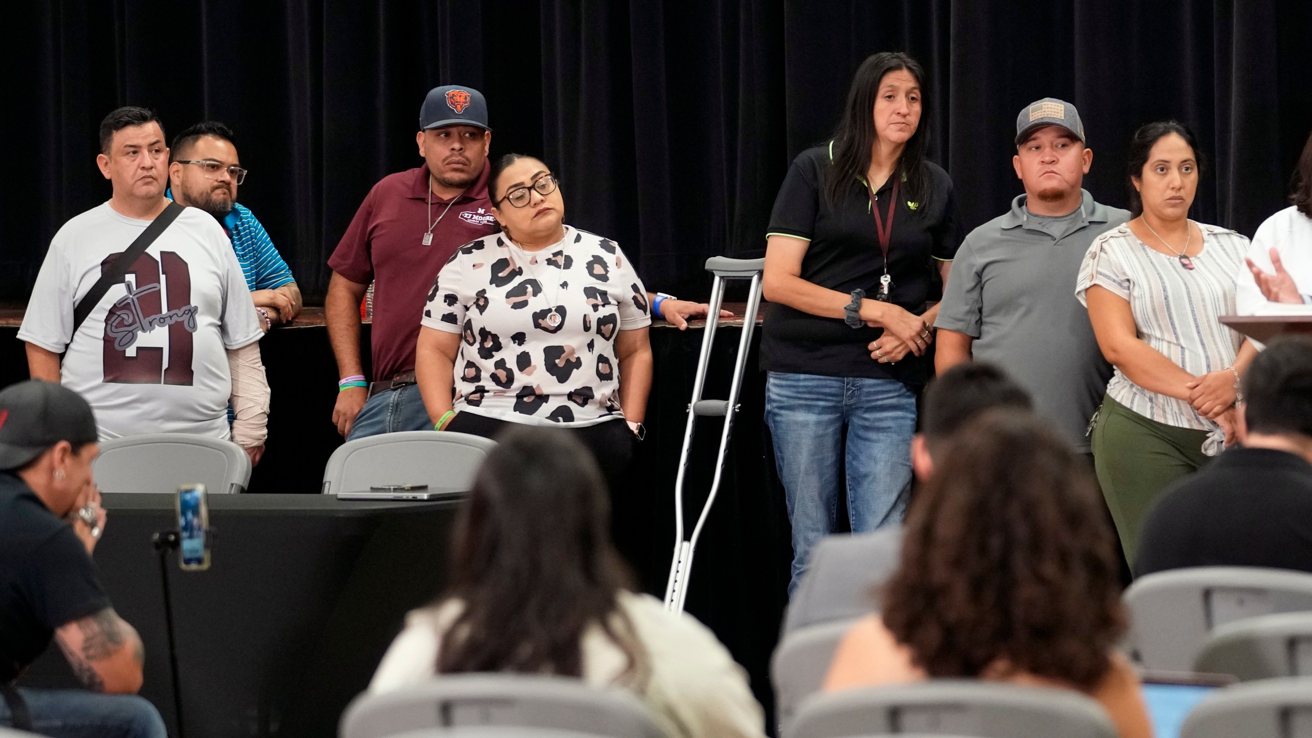 Families of the victims in the Uvalde elementary school shooting listen to attorney Josh Koskoff during a news conference, Wednesday, May 22, 2024, in Uvalde, Texas. The families of 19 of the victims announced a lawsuit against nearly 100 state police officers who were part of the botched law enforcement response. The families say they also agreed a $2 million settlement with the city, under which city leaders promised higher standards and better training for local police. (AP Photo/Eric Gay)