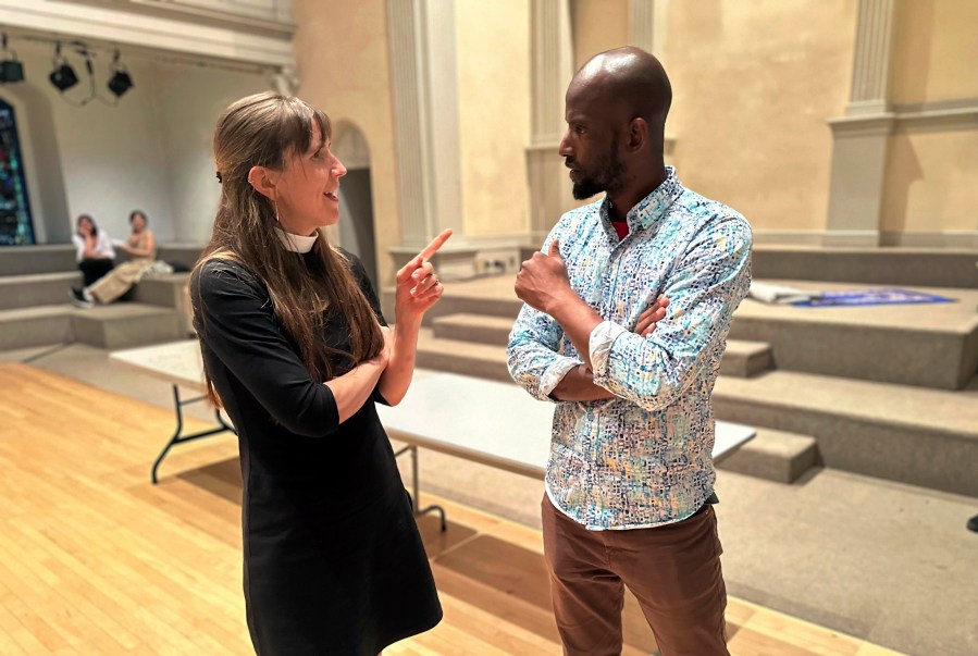 Mamadou Diallo, 39, of Senegal, speaks with Rev. Anne Marie Witchger at St. Mark's Church-in-the-Bowery, Wednesday, May 22, 2024, a lower Manhattan Episcopal church that operates a "welcome center" for migrants on Wednesdays. (AP Photo/Philip Marcelo)