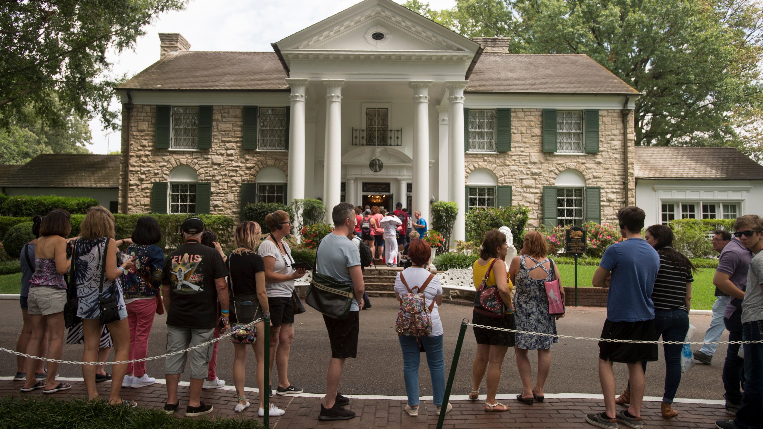 FILE - Fans wait in line outside Graceland Tuesday, Aug. 15, 2017, in Memphis, Tenn. A Tennessee judge on Wednesday, May 22, 2024, blocked the auction of Graceland, the former home of Elvis Presley, by a company that claimed his estate failed to repay a loan that used the property as collateral. (AP Photo/Brandon Dill, File)