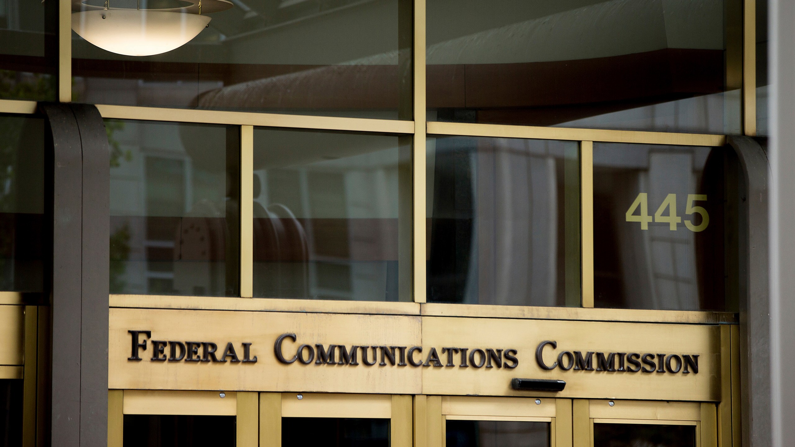 FILE - This June 19, 2015, file photo, shows the Federal Communications Commission building in Washington. The Federal Communications Commission has issued a $6 million fine against the political consultant who sent AI-generated robocalls mimicking President Joe Biden’s voice to voters ahead of New Hampshire’s presidential primary. Steve Kramer also faces two dozen criminal charges in New Hampshire. Kramer has admitted orchestrating the message sent to thousands of voters. (AP Photo/Andrew Harnik, File)