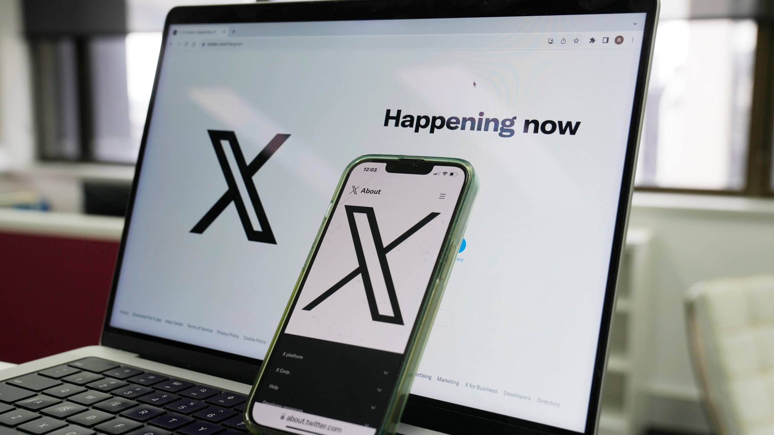 FILE - The opening page of X is displayed on a computer and phone in Sydney on Oct. 16, 2023. (AP Photo/Rick Rycroft, File)