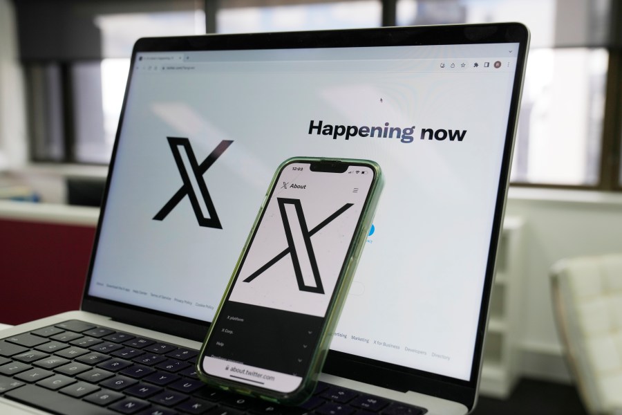 FILE - The opening page of X is displayed on a computer and phone in Sydney on Oct. 16, 2023. (AP Photo/Rick Rycroft, File)