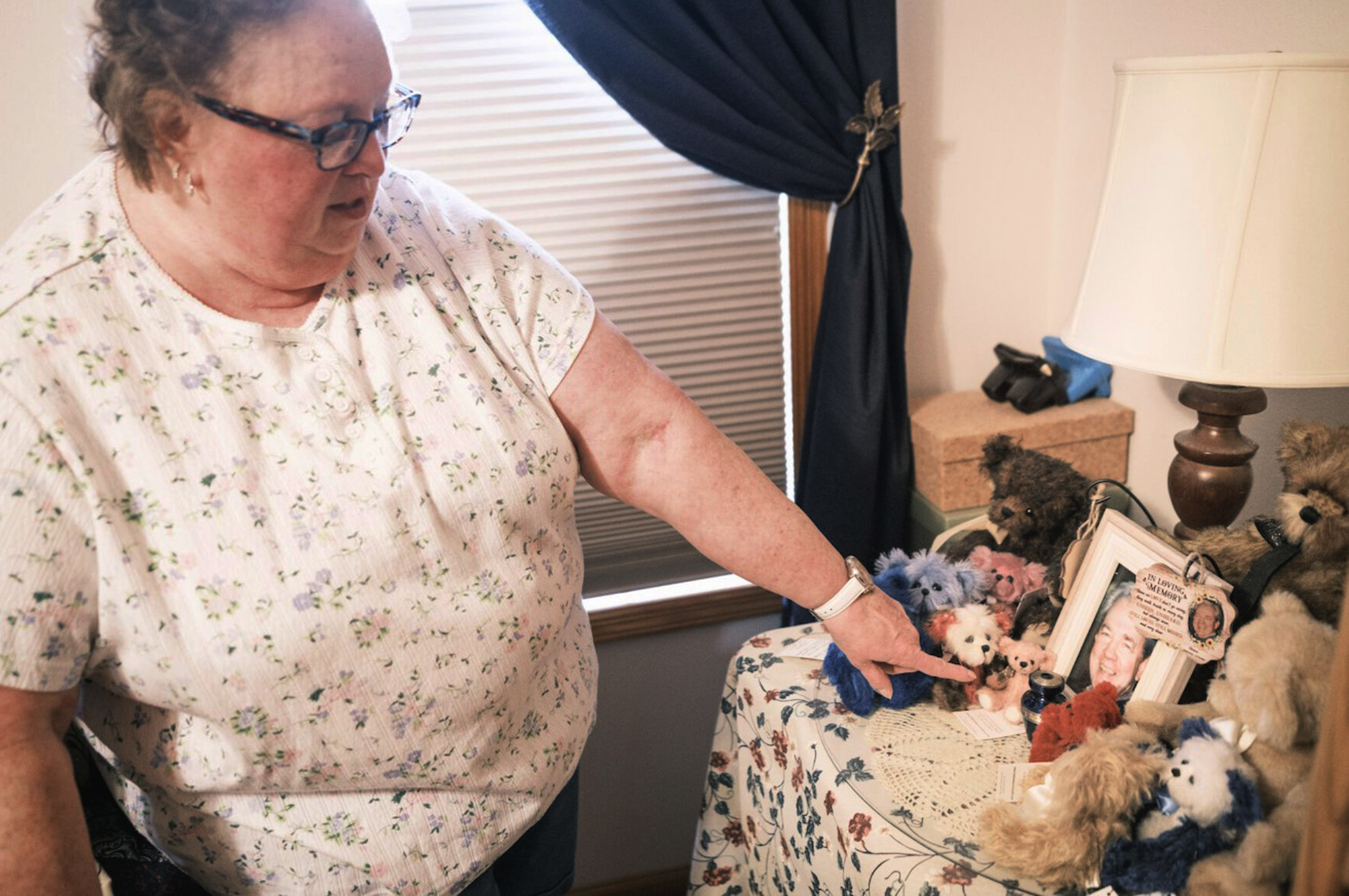 Nancy Gag Braun points to a small urn holding the ashes of her late husband Steve Braun, in her Mankato, Minn., bedroom on May 13, 2024. After caring for Steven at home became too much for her to handle, he was at the hospital while they waited on a long-term care placement. “I cried many nights,” Braun said. “I felt so guilty.” (Casey Ek/CNHI News via AP)