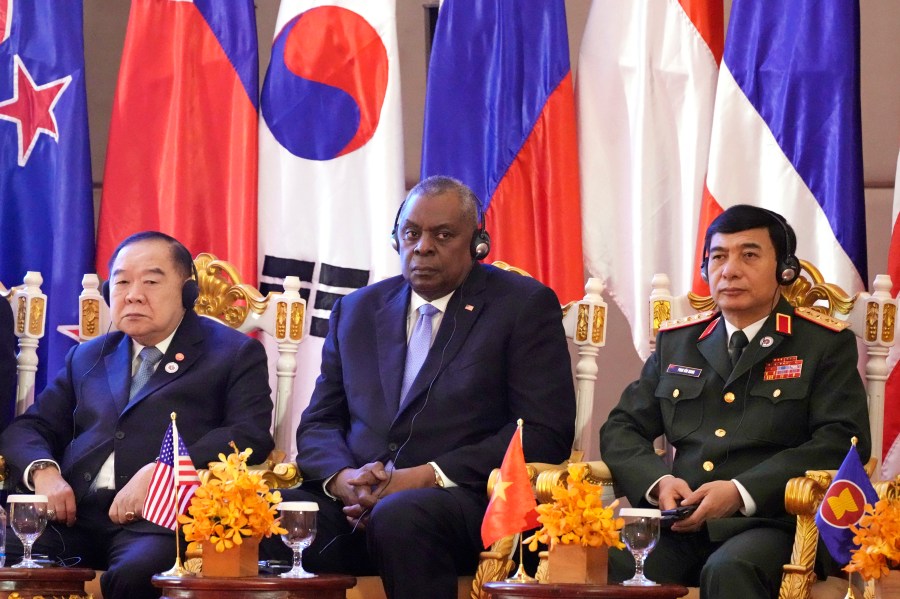 FILE - U.S. Secretary of Defense Lloyd Austin, center, Vietnam Minister of Defense Phan Van Giang, right, and Thai Deputy Prime Minister Prawit Wongsuwon, left, listen to a speech by Cambodian Prime Minister Hun Sen, during the 9th ASEAN Defense Ministers' Meeting Plus in Siem Reap, Cambodia, Wednesday, Nov. 23, 2022. U.S. Defense Secretary Lloyd Austin is scheduled to make an official visit to Cambodia, one of China's closest allies in Southeast Asia, after holding talks with his Chinese counterpart at an annual security conference in Singapore, officials said in a statement issued Friday, May 24, 2024. (AP Photo/Heng Sinith, File)