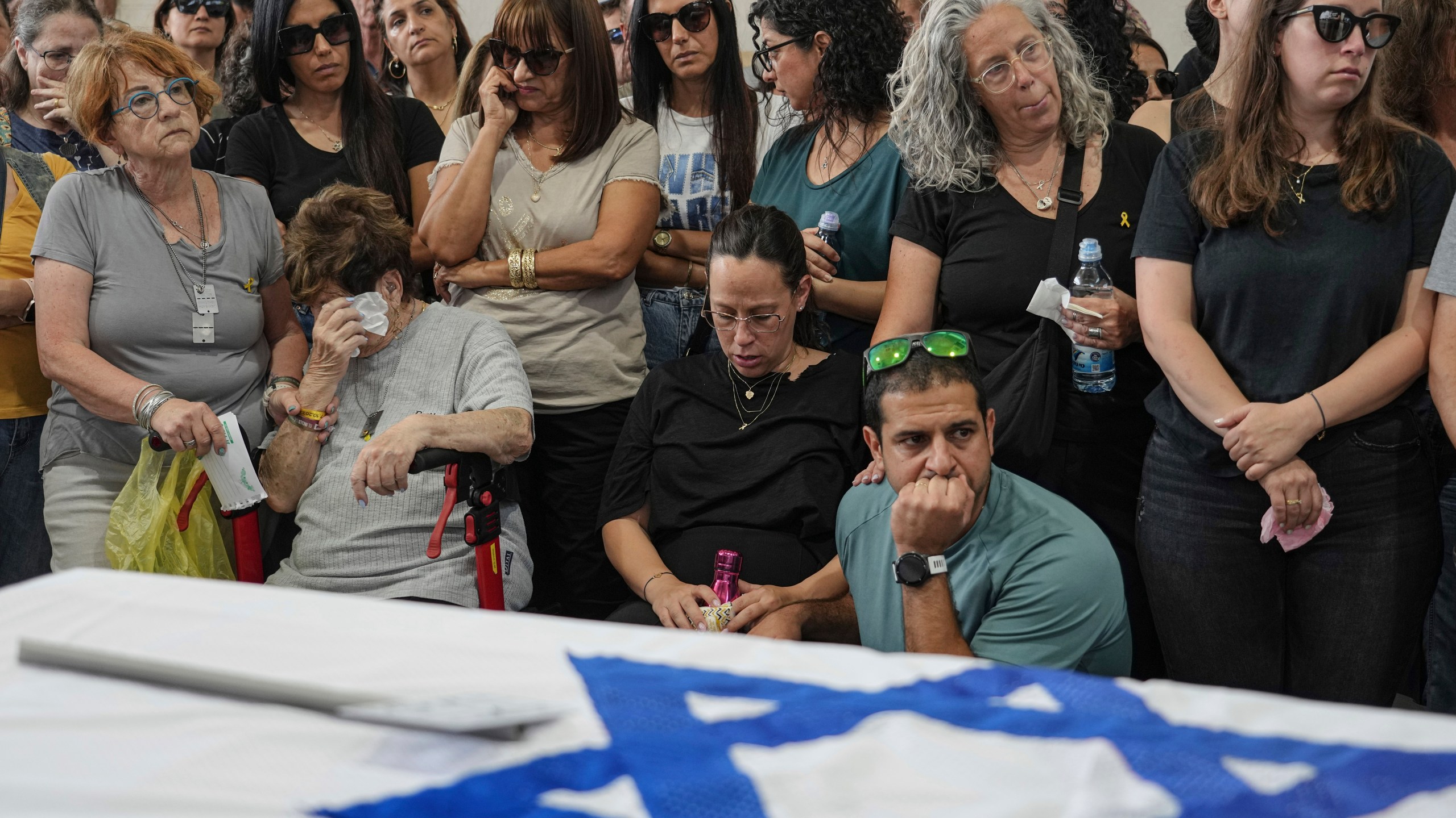 Mourners attend the funeral of Michel Nisenbaum, who was killed during Hamas' Oct. 7 attack and whose body was taken into Gaza, in Ashkelon, Israel, on Sunday, May 26, 2024. The Israeli military recovered Nisenbaum's remains, along with those of two other Israelis killed during the attack, in an operation in Gaza last week. (AP Photo/Tsafrir Abayov)