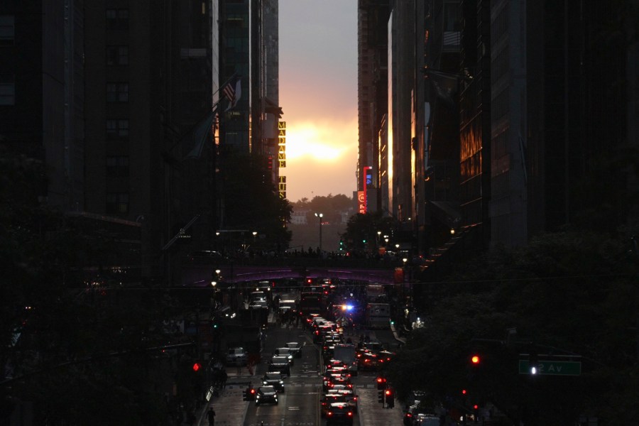 Clouds obscure the view of the setting sun on 42nd street in New York, Tuesday, May 28, 2024. Twice per year, New Yorkers and visitors are treated to a phenomenon known as Manhattanhenge, when the setting sun aligns with the Manhattan street grid and sinks below the horizon framed in a canyon of skyscrapers. (AP Photo/Mary Conlon)