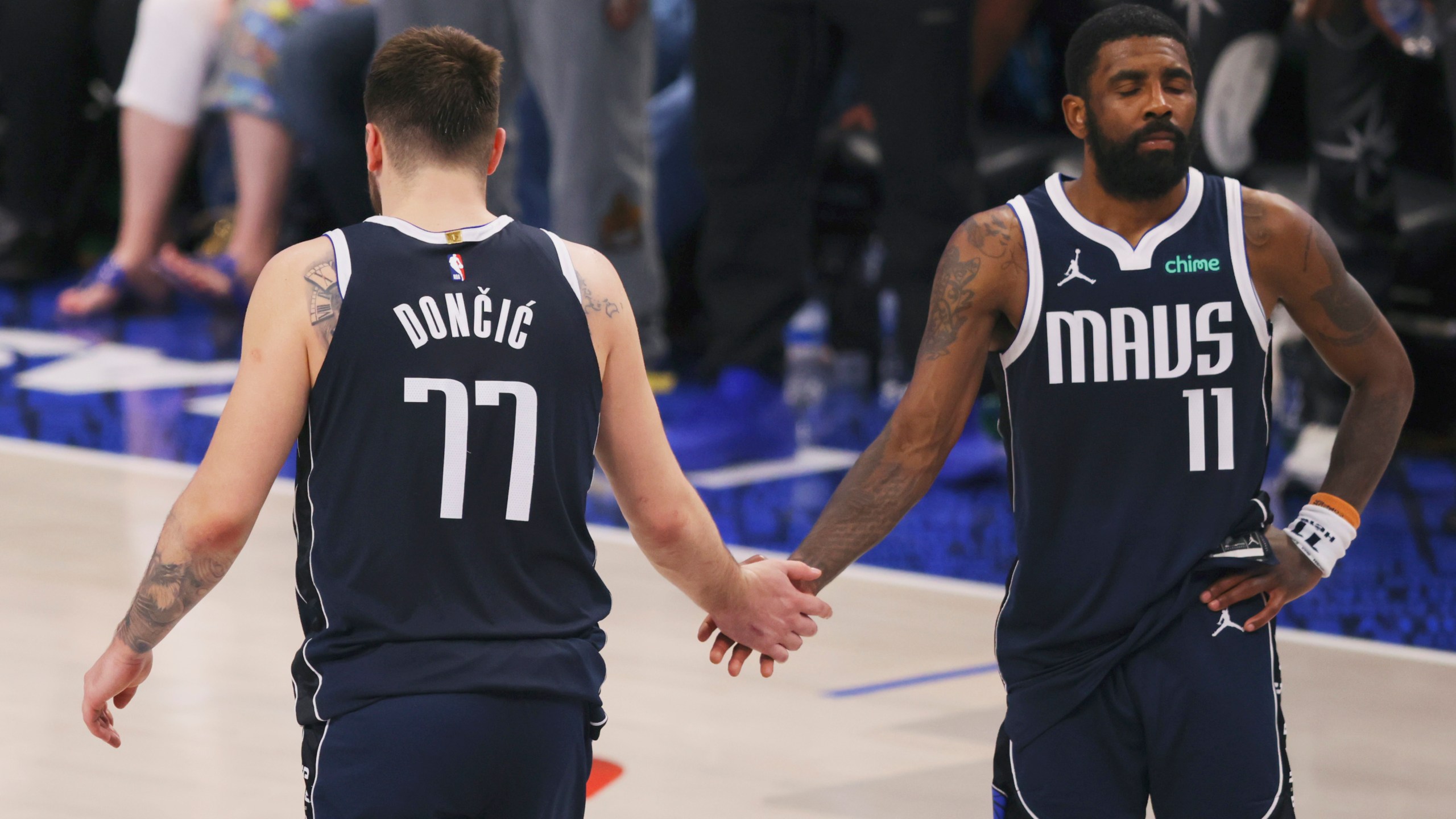 Dallas Mavericks guard Luka Doncic (77) shakes hands with teammate Kyrie Irving (11) after their loss to the Minnesota Timberwolves in Game 4 of the NBA basketball Western Conference finals, Tuesday, May 28, 2024, in Dallas. (AP Photo/Gareth Patterson)