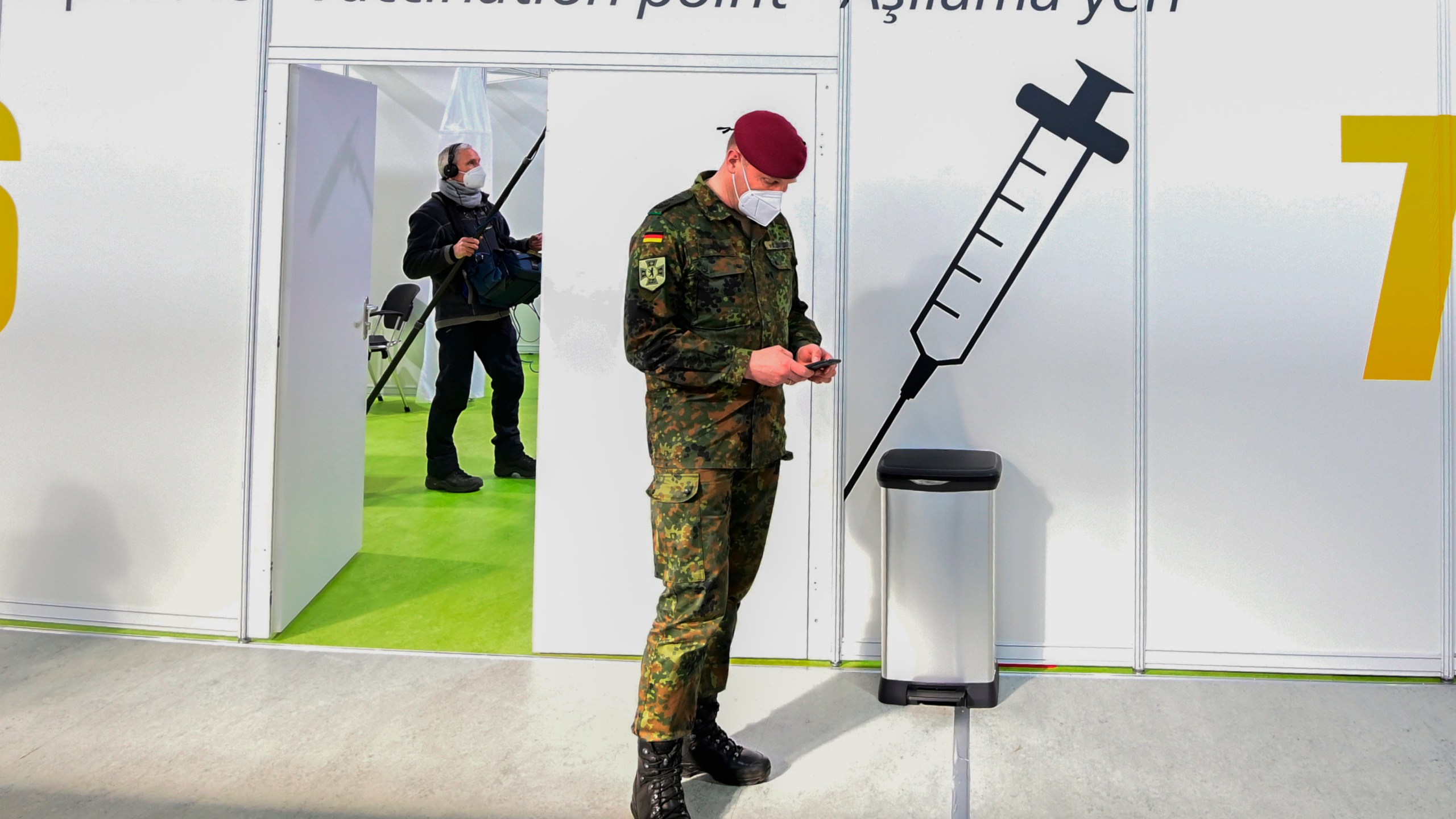 FILE - A soldier of the German Armed Forces Bundeswehr stands inside a new vaccination centre at the former Tempelhof airport in Berlin, Germany, before its opening on Monday, March 8, 2021. Germany has scrapped a requirement for its military servicepeople to be vaccinated against COVID-19. Members of the German military, the Bundeswehr, are required to get vaccinations against a number of diseases — including measles, mumps and flu. COVID-19 was added to the list in November 2021, meaning that anyone who refused to get vaccinated against it could face disciplinary measures. (Tobias Schwarz / Pool via AP, File)