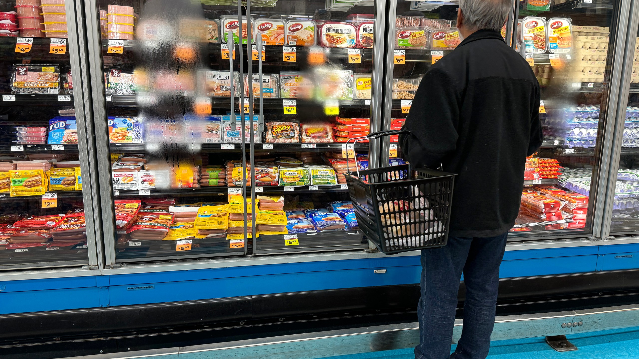 A customer shops for food at a grocery store on March 12, 2024 in San Rafael, California.