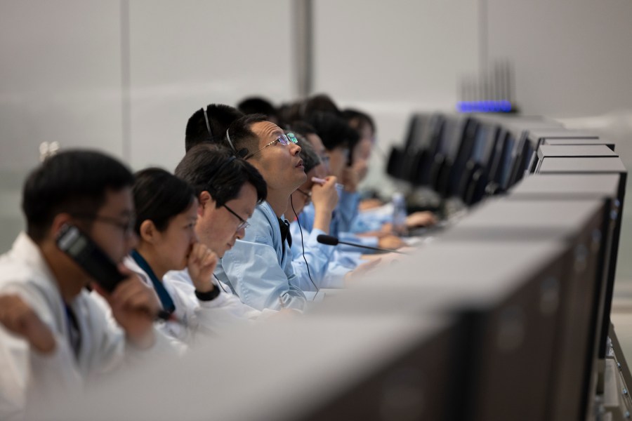 In this photo released by Xinhua News Agency, technical personnel work at the Beijing Aerospace Control Center (BACC) in Beijing, Sunday, June 2, 2024. A Chinese spacecraft landed on the far side of the moon Sunday to collect soil and rock samples that could provide insights into differences between the less-explored region and the better-known near side. (Jin Liwang/Xinhua via AP)