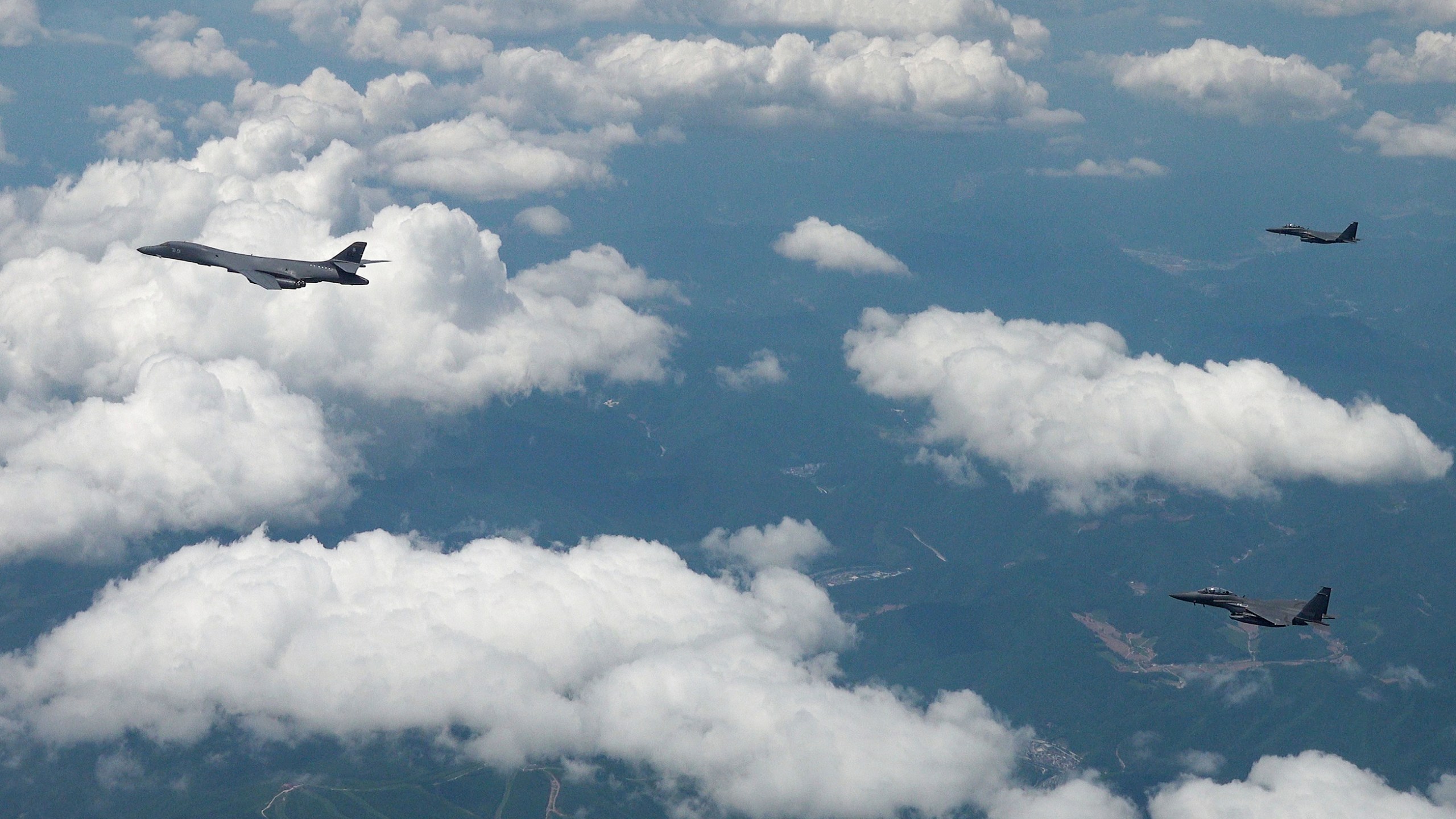 In this photo provided by the South Korea Defense Ministry, U.S. Air Force B-1B bomber, left, and South Korean fighter jets F-15K fly over the Korean Peninsula during the joint aerial drills between South Korea and the United States, South Korea, Wednesday, June 5, 2024. (South Korea Defense Ministry via AP)