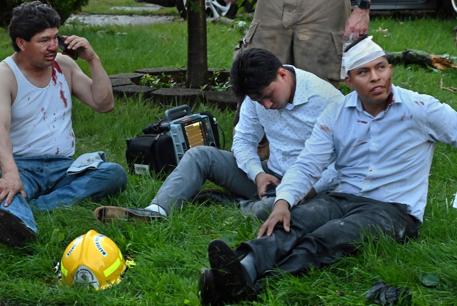 Injured tornado victims are moved to the front yard of a neighbor's home in Gaithersburg, Md., Wednesday, June 5, 2024, before being transported to a hospital. Several people were hurt when a large tree collapsed on a house on Dogwood Drive. (Michael S. Williamson/The Washington Post via AP)