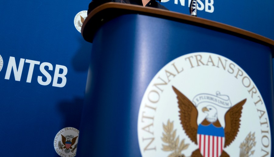 FILE - The National Transportation Safety Board logo and signage are seen at a news conference at NTSB headquarters in Washington, Dec. 18, 2017. Investigators said Thursday, June 6, 2024, that an incoming FedEx cargo plane came within less than 200 feet of hitting a Southwest Airlines jet last year in Austin, Texas, after both were cleared to use the same runway. (AP Photo/Andrew Harnik, File)