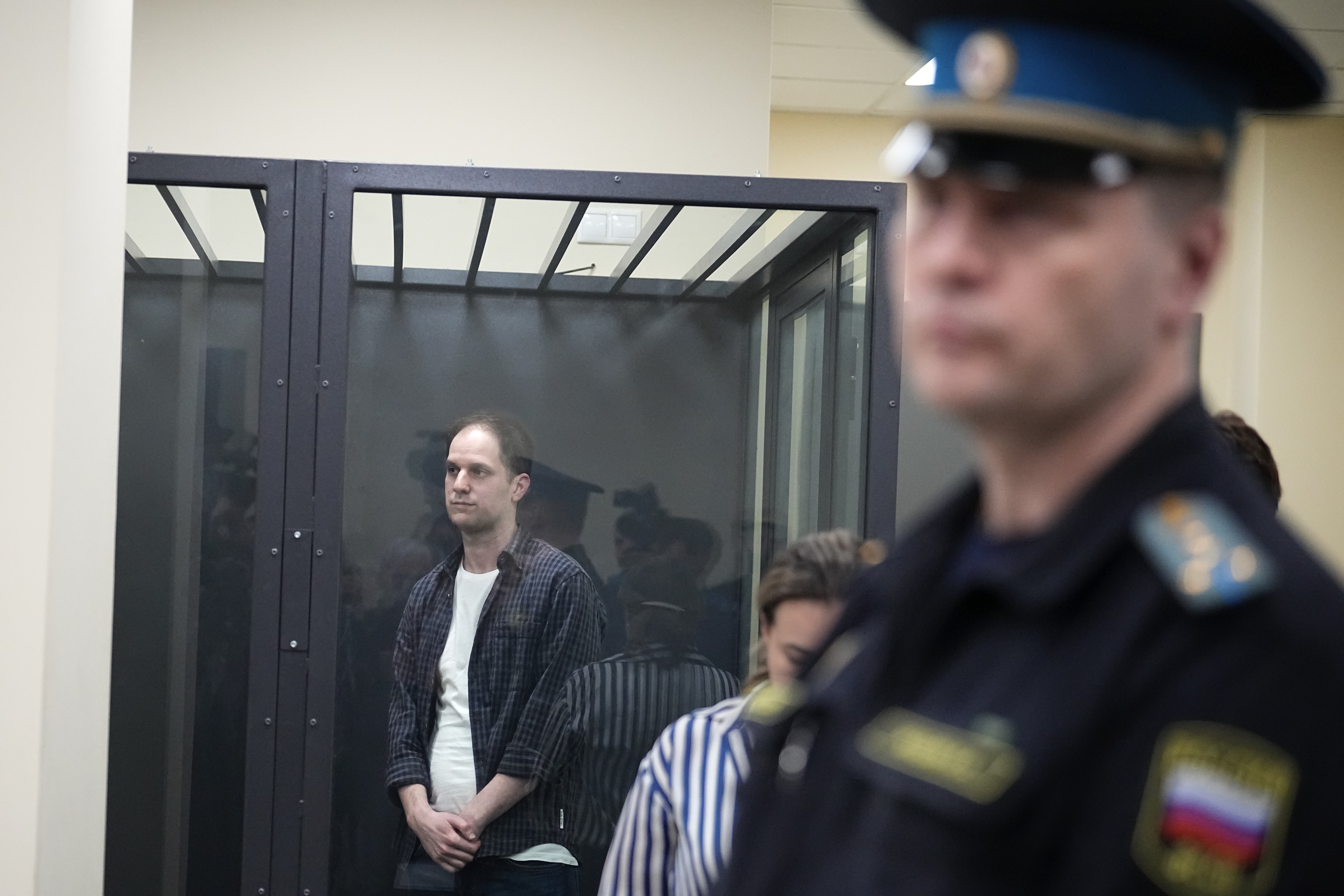 FILE - Wall Street Journal reporter Evan Gershkovich, left, stands in a glass cage in a courtroom at the First Appeals Court of General Jurisdiction in Moscow, Russia, Tuesday, April 23, 2024. Arrests on charges of spying and collecting sensitive data have become increasingly frequent in Russia since it sent troops into Ukraine in February 2022. Recent high-profile arrests include Wall Street Journal reporter Evan Gershkovich, who was arrested on espionage charges in March 2023. (AP Photo/Alexander Zemlianichenko, File)