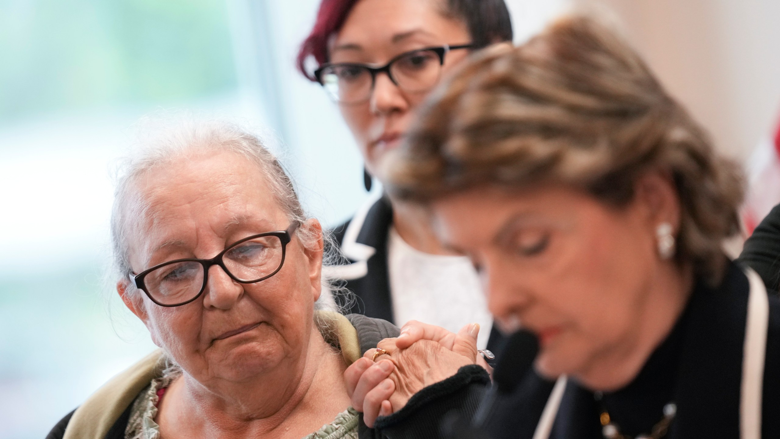 Jessica Taylors' mother, Elizabeth Baczkiel, left, listens as attorney Gloria Allred, right, reads her statement during a news conference in Riverhead, N.Y., Thursday, June 6, 2024. Rex Heuermann, previously accused of killing four women and leaving their corpses scattered along a coastal highway, was charged Thursday, in the deaths of two more, Taylor and Sandra Costil, after prosecutors said they gathered new DNA evidence and found a computer document he had used to "blueprint" his crimes. (AP Photo/Seth Wenig)