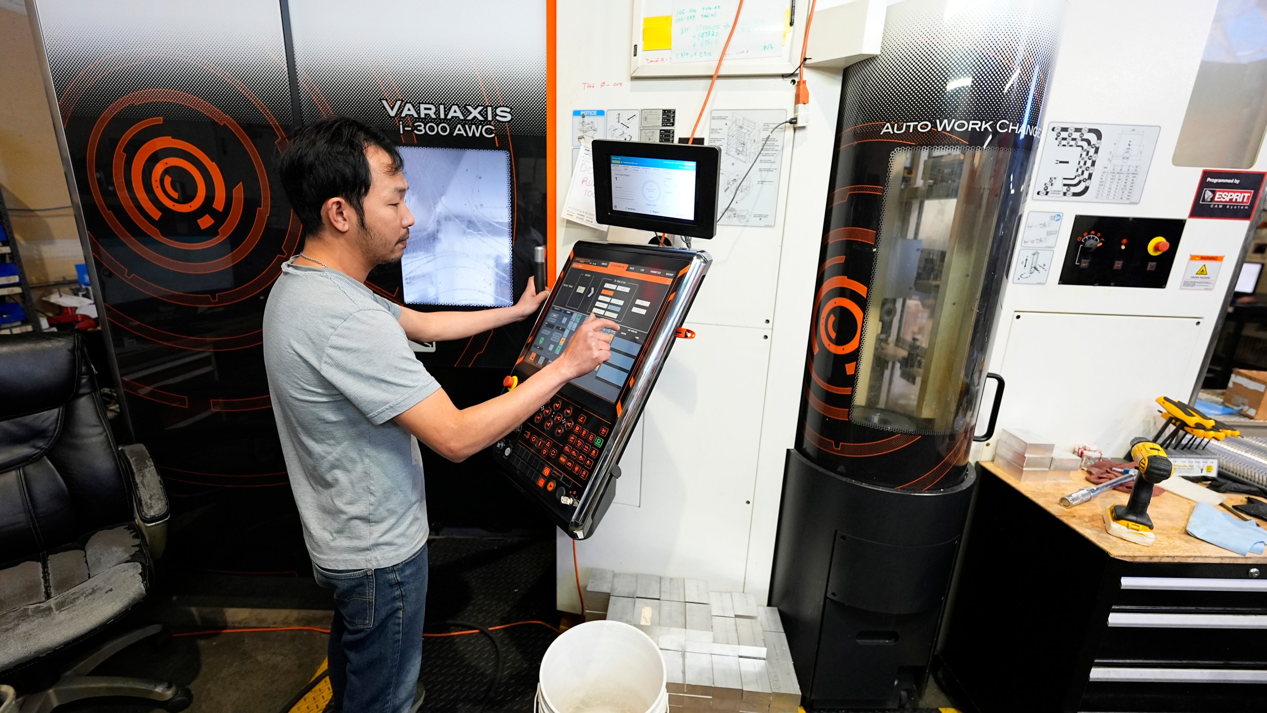 FILE - A worker at Reata Engineering and Machine Works programs a Mazak Variaxis machine used to make semiconductor pieces on Feb. 15, 2024, in Englewood, Colo. On Friday, June 7, 2024, the U.S. government issues its May jobs report. (AP Photo/David Zalubowski, File)