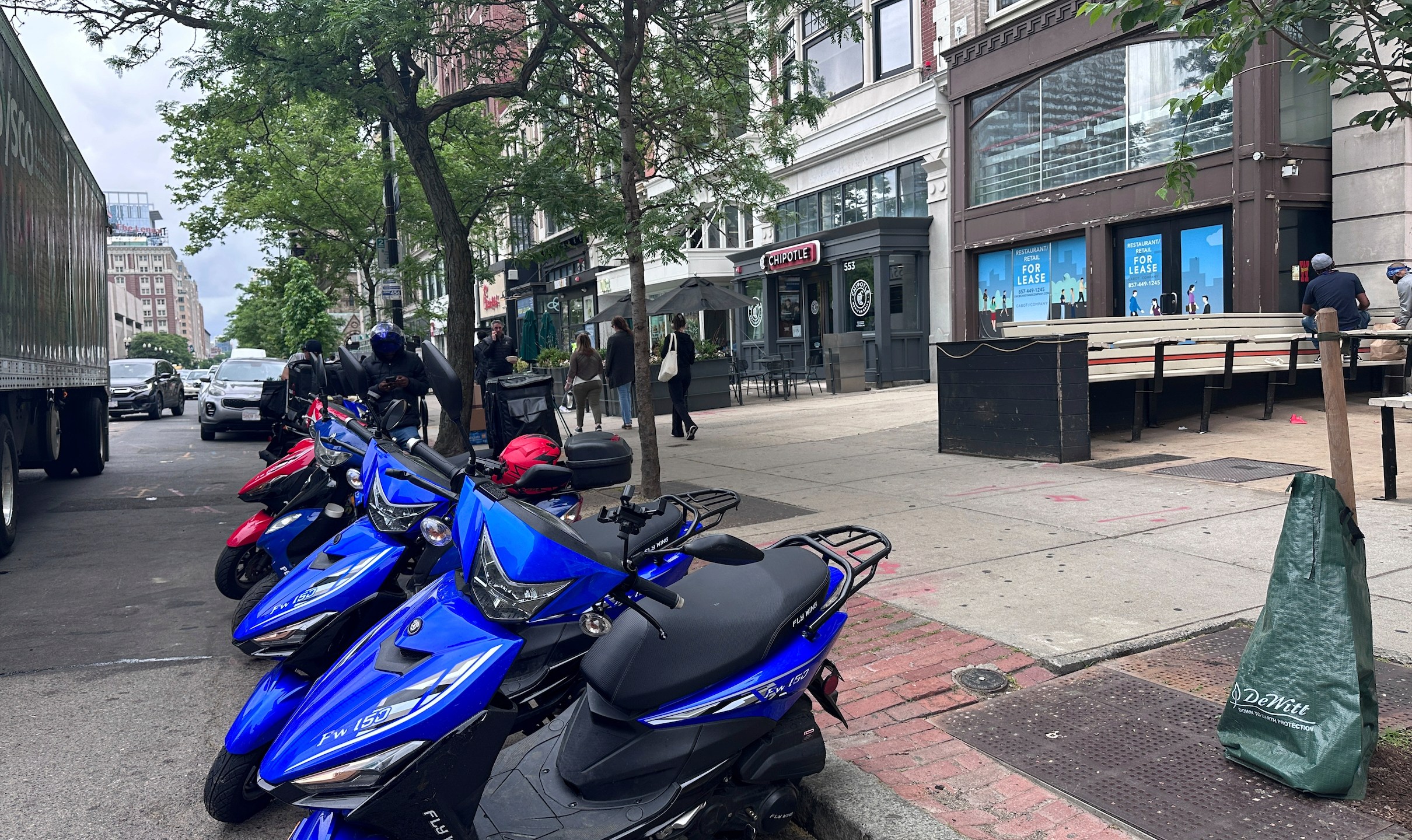 Delivery scooters are parked as drivers wait to pick up food for delivery, Thursday, June 6, 2024, in Boston. Boston and New York are cracking down on unlawful drivers, whom they say are ignoring traffic laws and making city streets more dangerous. (AP Photos/Michael Casey)