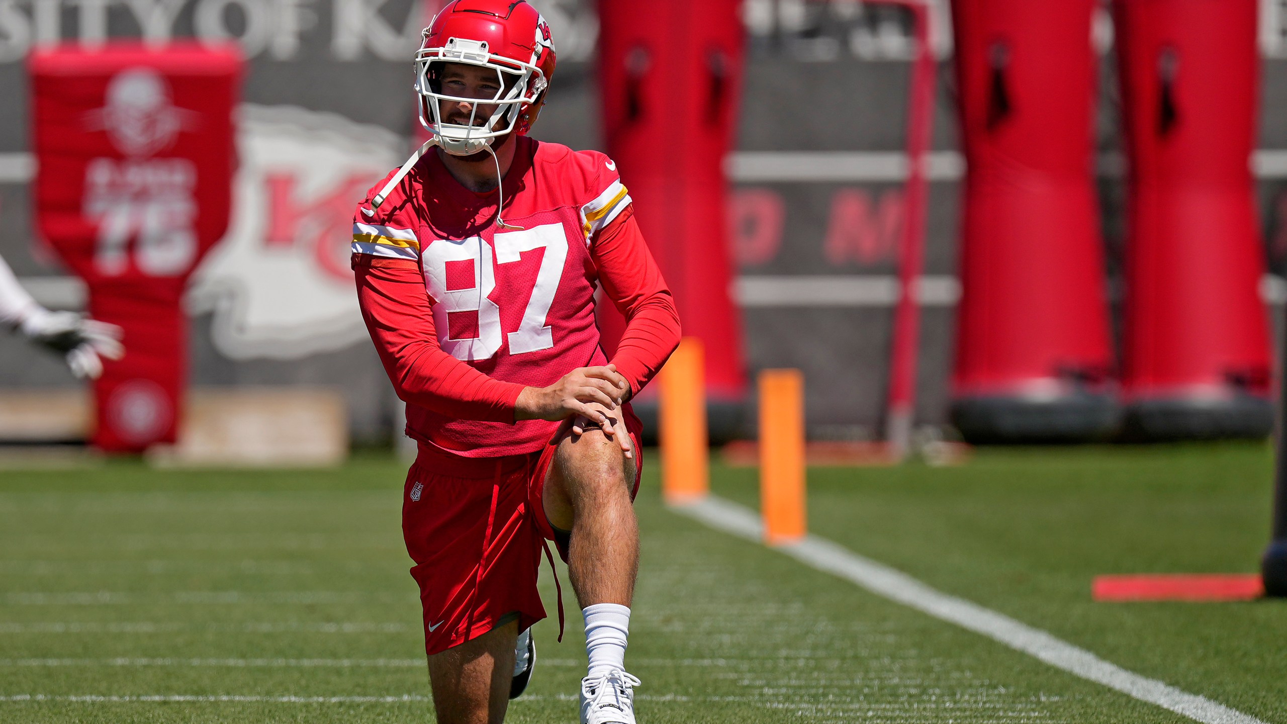 Kansas City Chiefs tight end Travis Kelce stretches during the NFL football team's organized team activities Friday, June 7, 2024, in Kansas City, Mo. (AP Photo/Charlie Riedel)