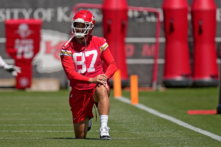 Kansas City Chiefs tight end Travis Kelce stretches during the NFL football team's organized team activities Friday, June 7, 2024, in Kansas City, Mo. (AP Photo/Charlie Riedel)