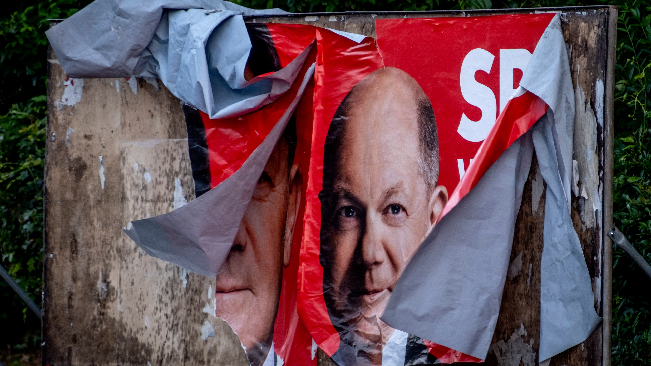 A damaged election poster shows German Chancellor Olaf Scholz in Frankfurt, Germany, Monday, June 10, 2024. (AP Photo/Michael Probst)