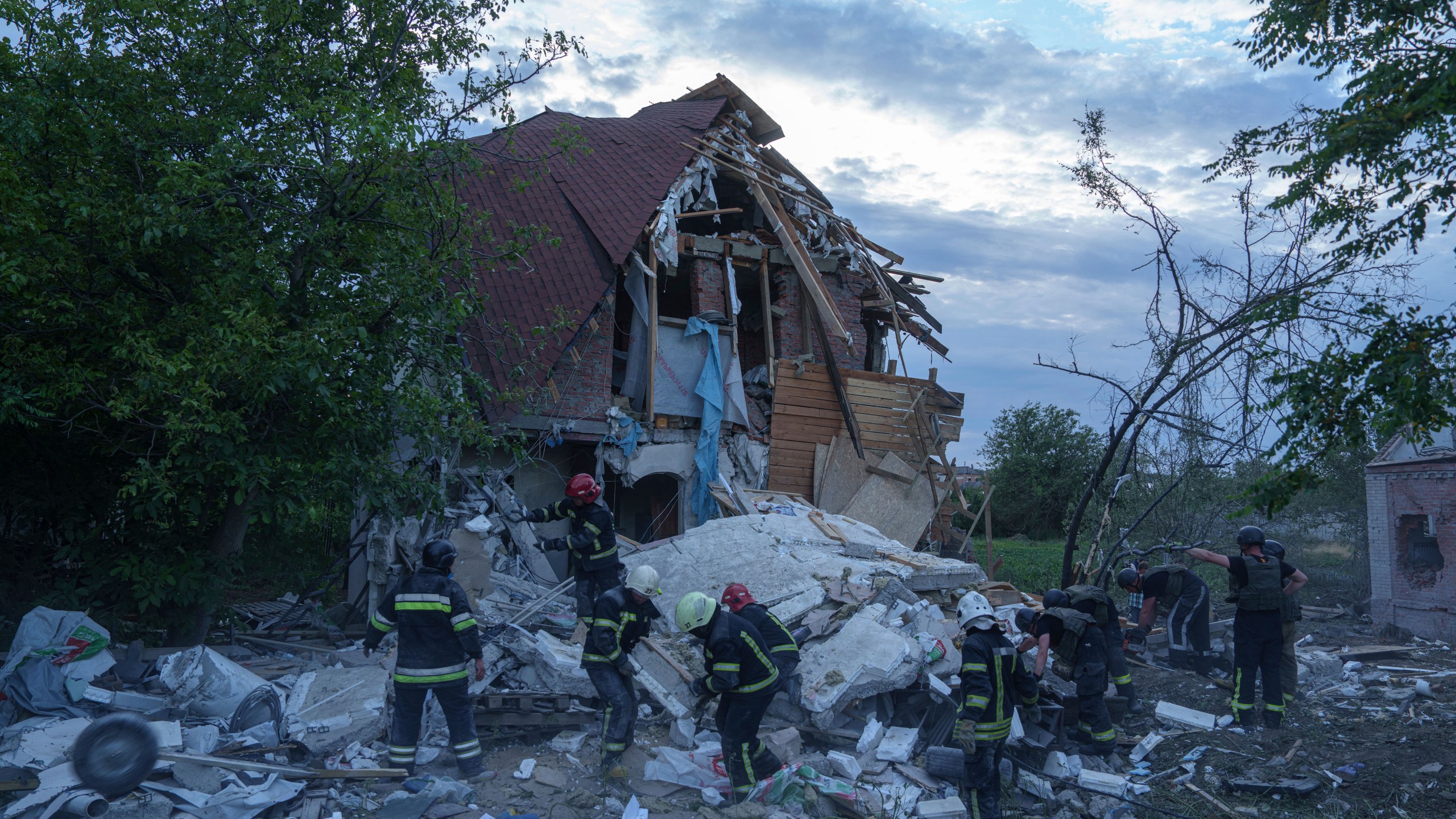 Rescue workers clear the rubble of a building which was destroyed by a Russian airstrike in Kharkiv, Ukraine, Monday, June 10, 2024. (AP Photo/Evgeniy Maloletka)