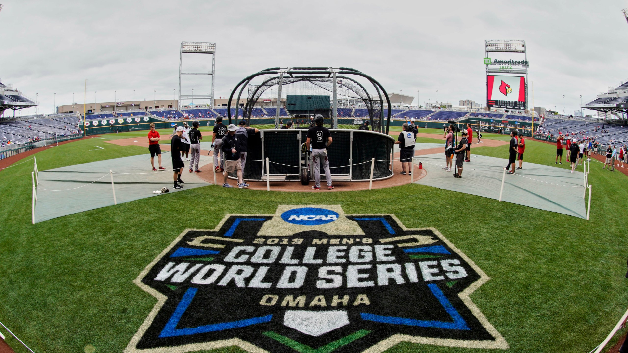 FILE - The College World Series logo is displayed in front of a batting cage during a Louisville team practice at TD Ameritrade Park, now Charles Schwab Field, in Omaha, Neb., June 14, 2019. The College World Series opens Friday, June 14, 2024, at Charles Schwab Field and only two conferences will be represented on the college game's biggest stage. The Southeastern Conference and Atlantic Coast Conference have combined to send the most teams to the CWS over the last decade, including this year. (AP Photo/Nati Harnik, File)