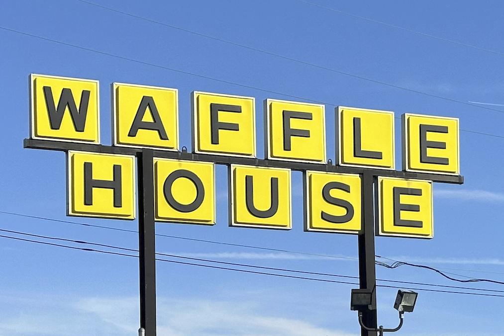 FILE - A Waffle House sign is shown in Indianapolis Feb. 19, 2024. Waffle House is increasing pay for its U.S. workers after a year-long push from labor advocates.(AP Photo/Isabella Volmert, File)