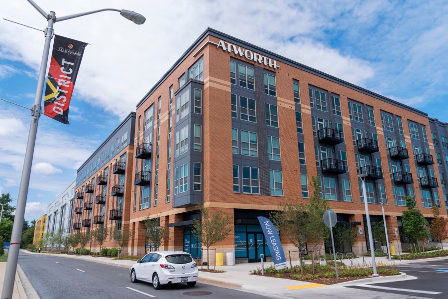 A car passes by the Atworth at College Park building in College Park, Md., Tuesday, June 11, 2024. The apartment building was built using investments from Amazon's Housing Equity Fund. The company said Tuesday its adding $1.4 billion to the fund in order to help preserve or construct more affordable housing units in three regions. (AP Photo/Jacquelyn Martin)