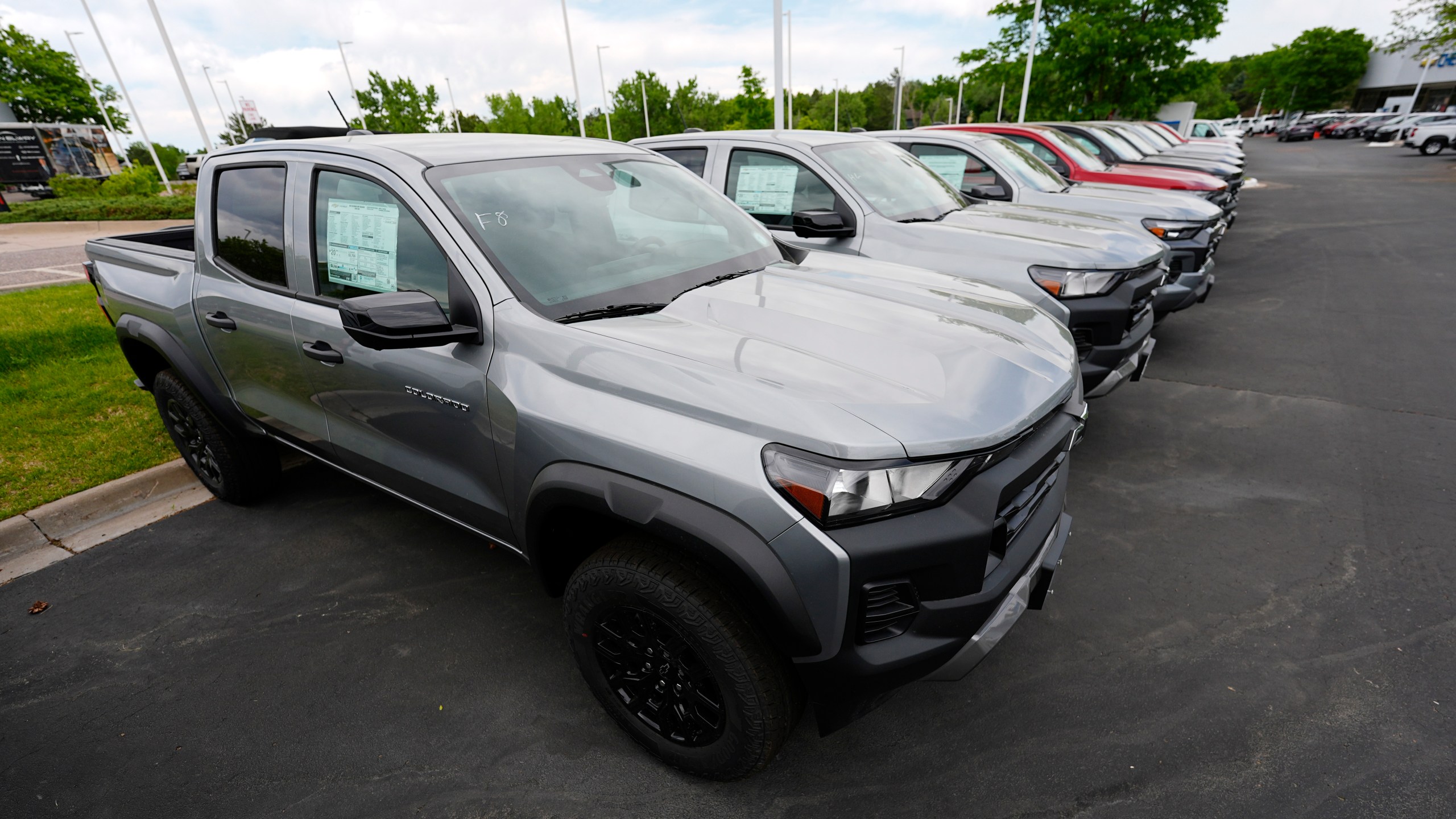 Unsold 2024 Colorado pickup trucks sit in a row outside a Chevrolet dealership Sunday, June 2, 2024, in Lone Tree, Colo. On Wednesday, June 12, 2024, the Labor Department issues its report on prices at the consumer level in May. (AP Photo/David Zalubowski)