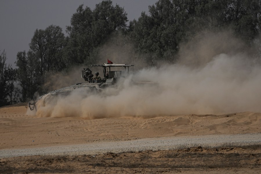 An Israeli military armored personnel carrier maneuvers near the Israel-Gaza border in southern Israel, Wednesday, June 12, 2024. (AP Photo/Tsafrir Abayov)