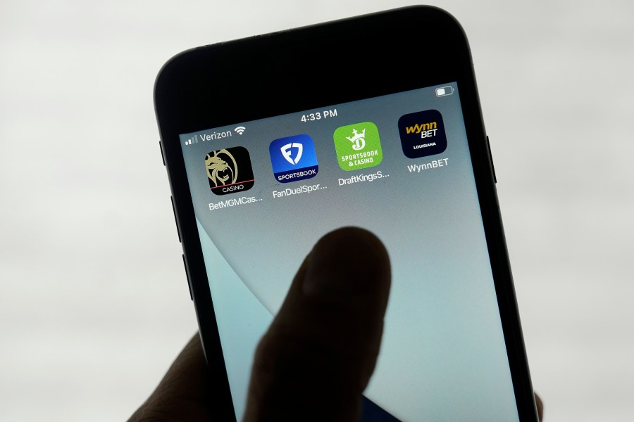 FILE - FanDuel, DraftKings and other online gambling apps are displayed on a phone in San Francisco, Sept. 26, 2022. Online sports gambling apps are facing tax hikes in some states this year. (AP Photo/Jeff Chiu, File)