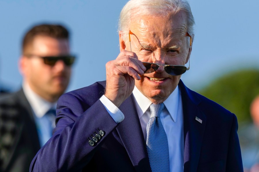 U.S. President Joe Biden puts on his sun glasses after watching a skydiving demo during the G7 world leaders summit at Borgo Egnazia, Italy, Thursday, June 13, 2024. (AP Photo/Luca Bruno)