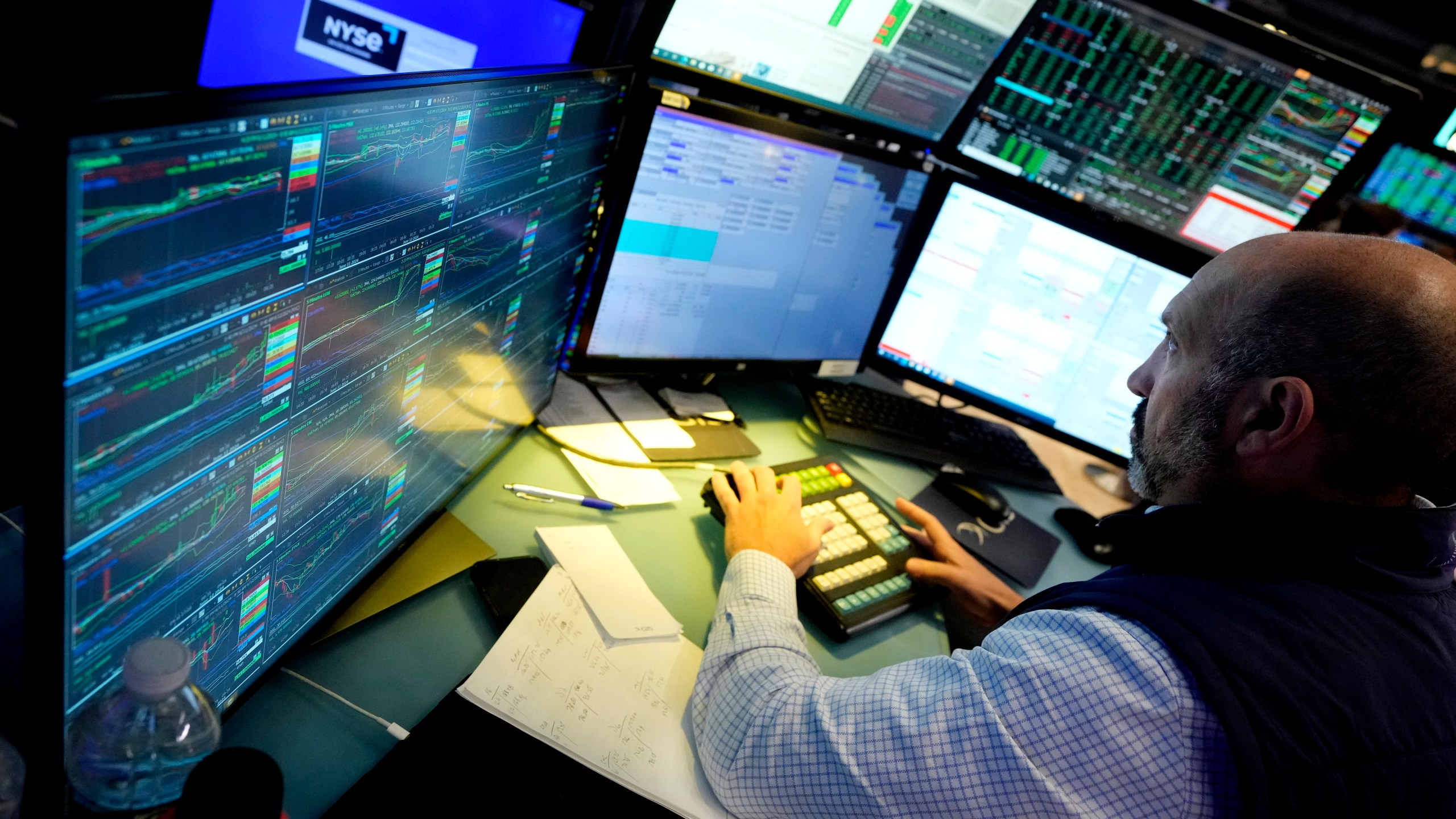 FILE - Specialist James Denaro works at his post on the floor of the New York Stock Exchange on June 12, 2024. Global shares were mixed on Friday, June 14, 2024, after Wall Street touched fresh records, with benchmarks pushed higher by the frenzy over artificial intelligence technology. (AP Photo/Richard Drew, File)