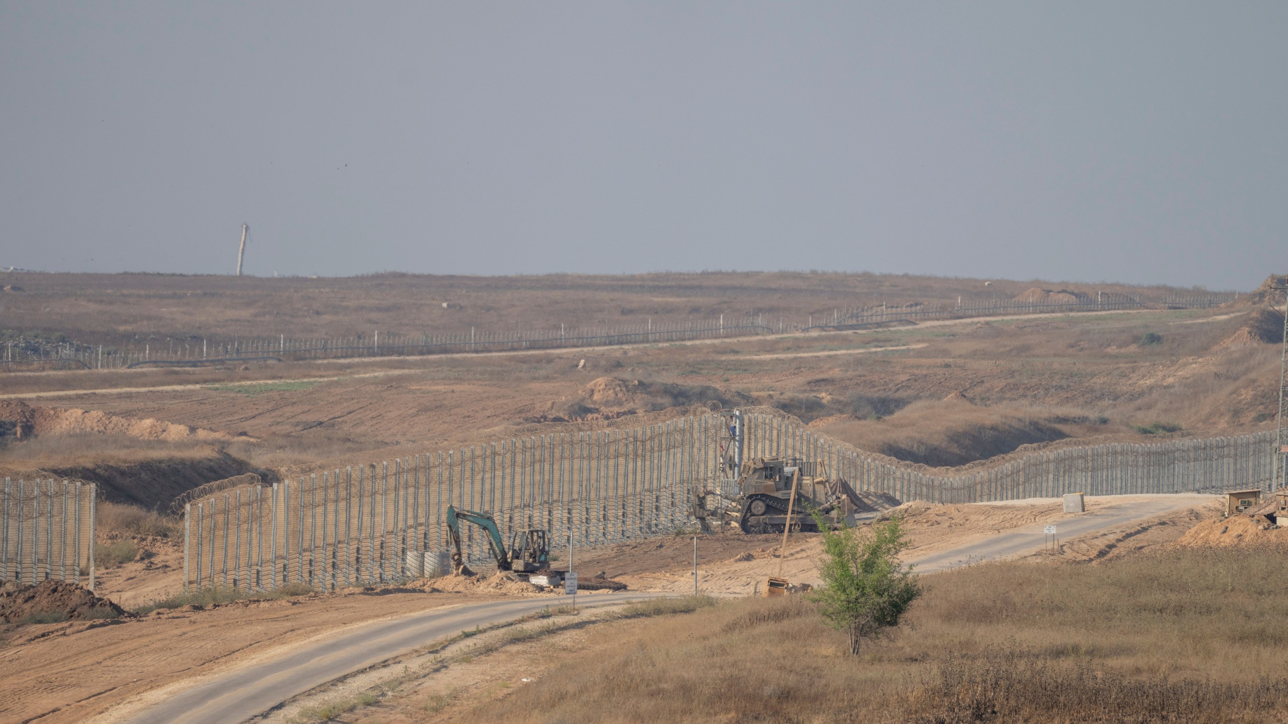 FILE - Israeli army bulldozers are seen near the Gaza Strip border, in southern Israel, Thursday, June 13, 2024. Israel's military said Saturday, June 15, that eight soldiers were killed in southern Gaza in the deadliest attack on Israeli forces in months. (AP Photo/Ohad Zwigenberg, File)