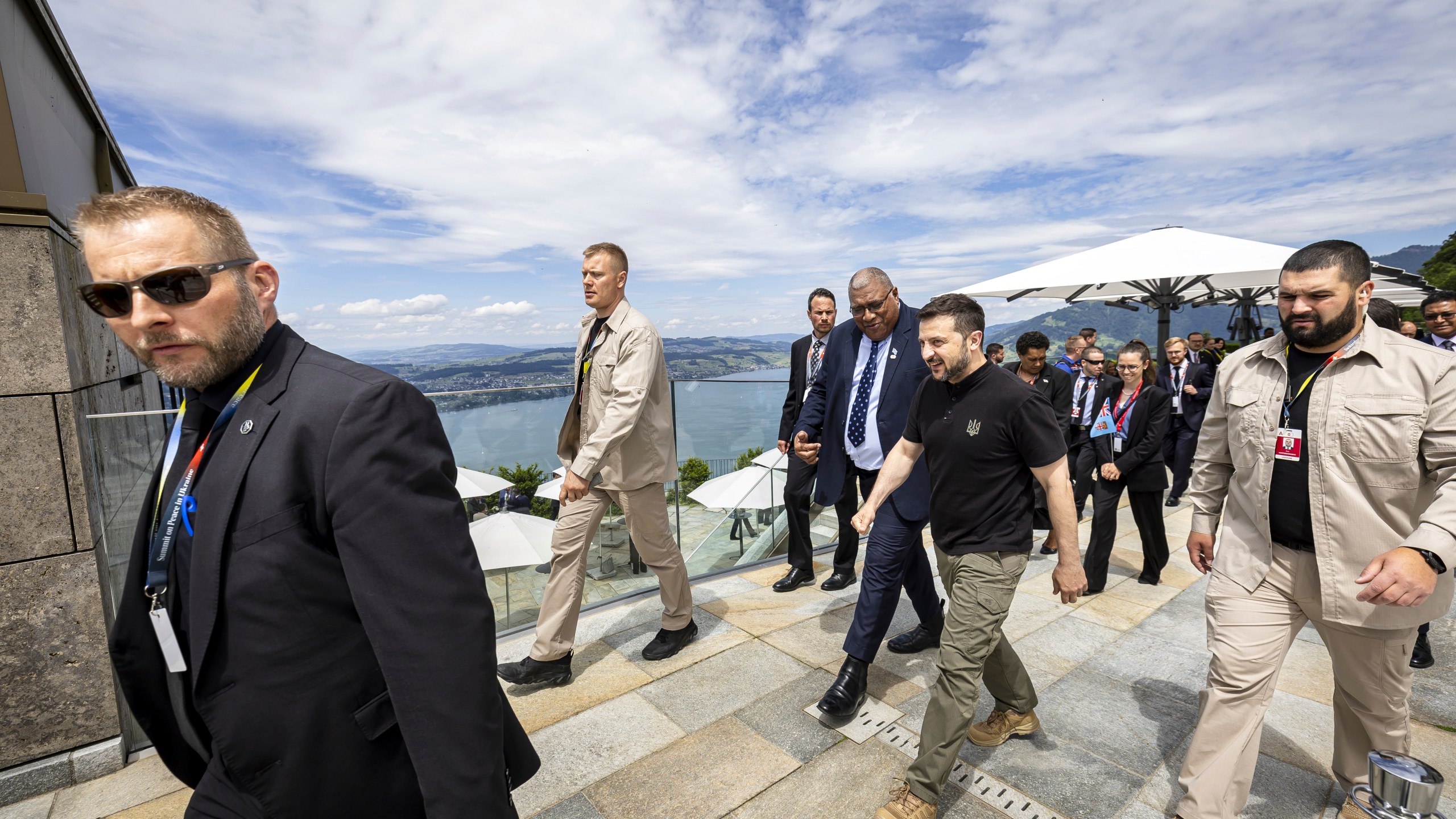 Ukrainian President Volodymyr Zelenskyy, centre, and Fiji's President Wiliame Maivalili Katonivere walk during the Summit on peace in Ukraine, in Obbürgen, Switzerland, Sunday, June 16, 2024. (Michael Buholzer/Keystone via AP)