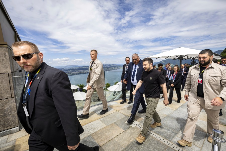 Ukrainian President Volodymyr Zelenskyy, centre, and Fiji's President Wiliame Maivalili Katonivere walk during the Summit on peace in Ukraine, in Obbürgen, Switzerland, Sunday, June 16, 2024. (Michael Buholzer/Keystone via AP)