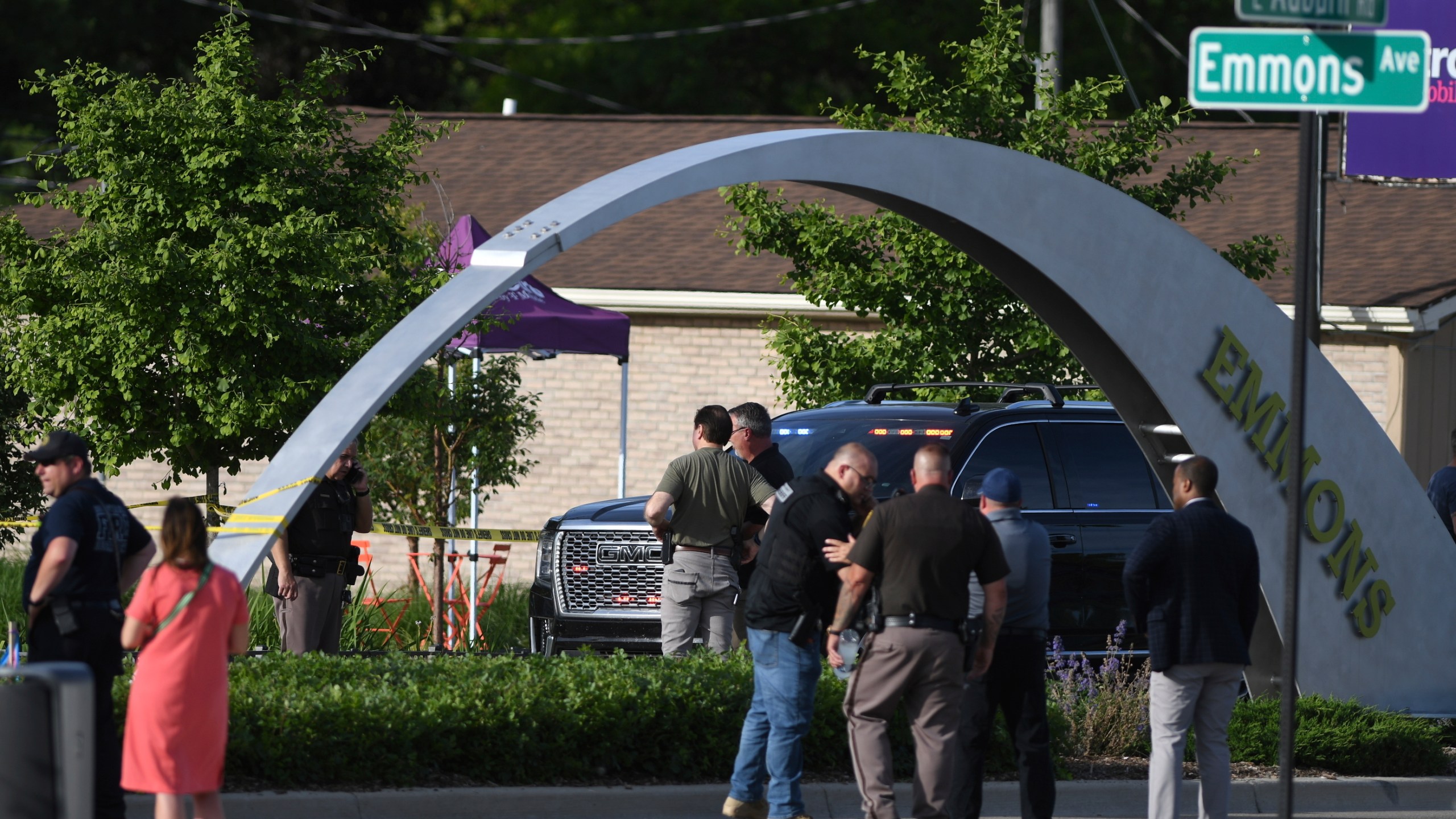 Officials with the Oakland County Sheriff's Department, Rochester Hills Fire Department and other jurisdictions secure the scene of a shooting at the Brooklands Plaza Splash Pad, Saturday, June 15, 2024, in Rochester Hills, Mich. (Daniel Mears/Detroit News via AP)