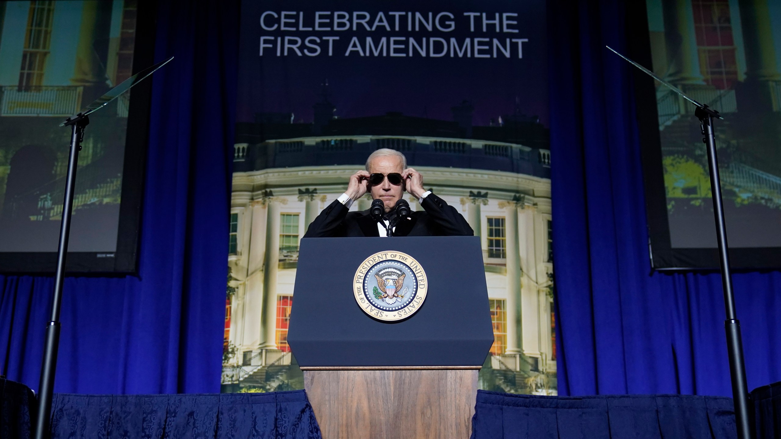 FILE - President Joe Biden puts on sunglasses after making a joke about becoming the "Dark Brandon" persona during the White House Correspondents' Association dinner at the Washington Hilton in Washington, April 29, 2023. Both presidential campaigns this year have embraced digital memes, the lingua franca of social media. (AP Photo/Carolyn Kaster, File)