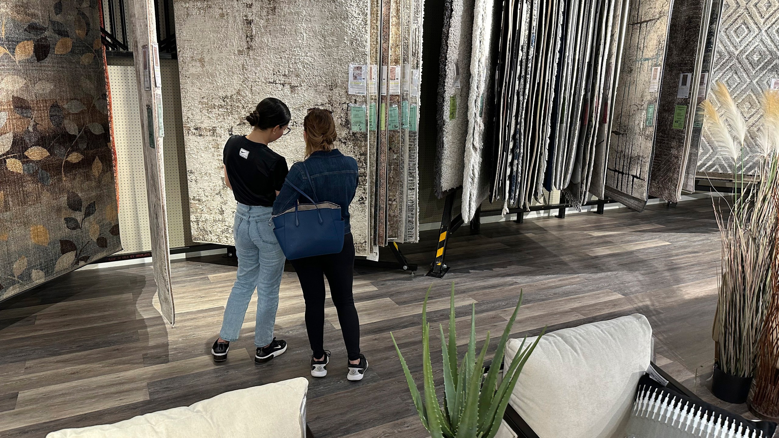 Shoppers consider rug samples on display in a furniture store Sunday, June 2, 2024, in Lone Tree, Colo. On Tuesday, June 18, 2024, the Commerce Department releases U.S. retail sales data for May. (AP Photo/David Zalubowski)