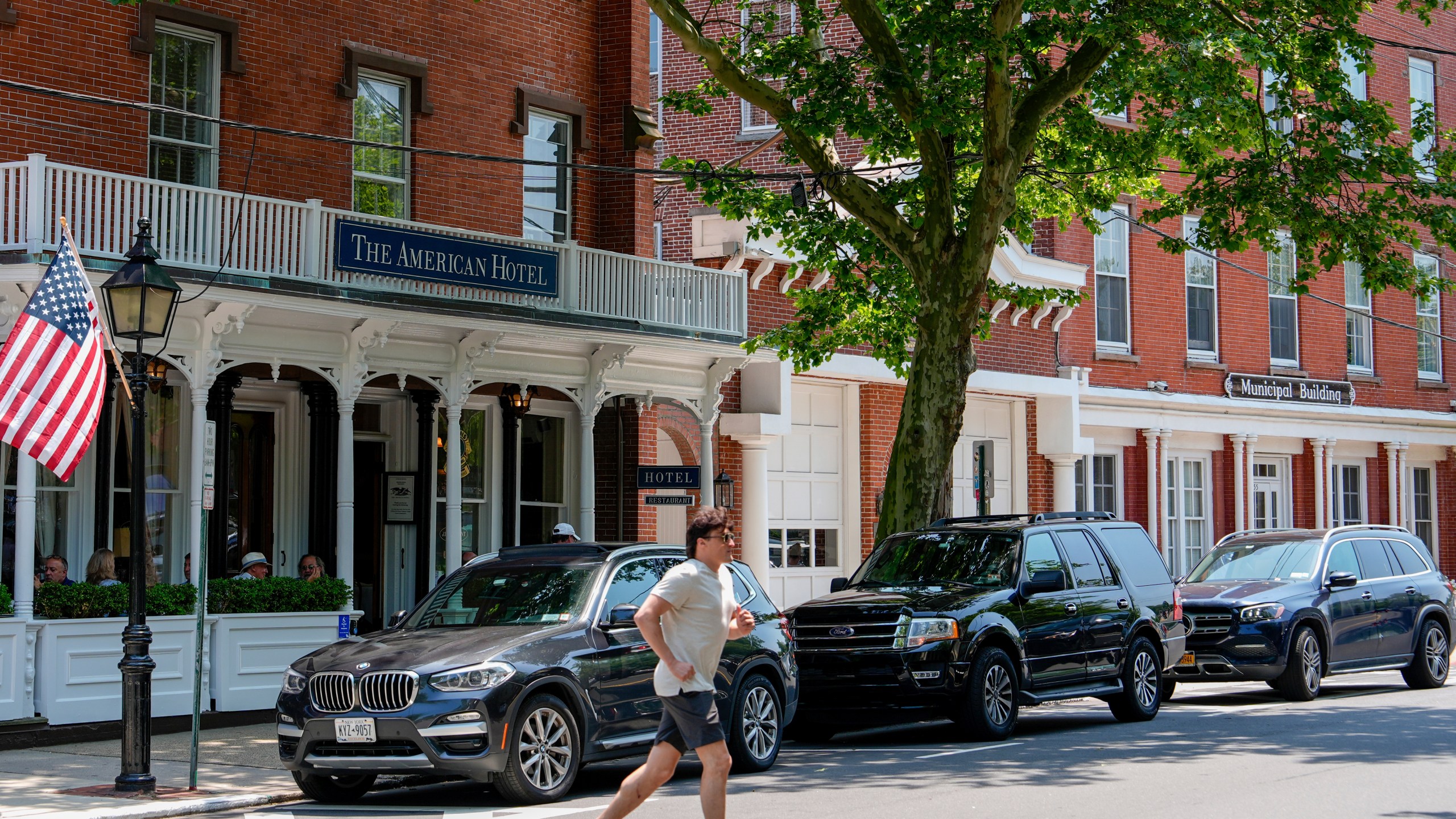 A man crosses in front of Sag Harbor Village Hall and The American Hotel, Tuesday, June 18, 2024, in Sag Harbor, N.Y. Pop star Justin Timberlake was charged early Tuesday with driving while intoxicated in Sag Harbor after police said he ran a stop sign and veered out of his lane in the posh seaside summer retreat. (AP Photo/Julia Nikhinson)