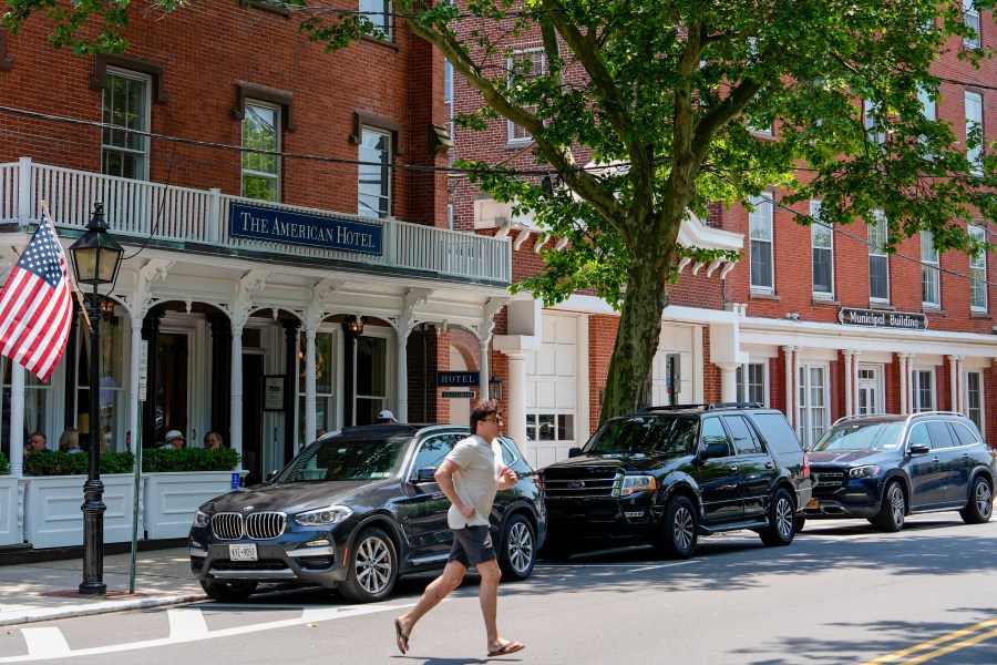 A man crosses in front of Sag Harbor Village Hall and The American Hotel, Tuesday, June 18, 2024, in Sag Harbor, N.Y. Pop star Justin Timberlake was charged early Tuesday with driving while intoxicated in Sag Harbor after police said he ran a stop sign and veered out of his lane in the posh seaside summer retreat. (AP Photo/Julia Nikhinson)