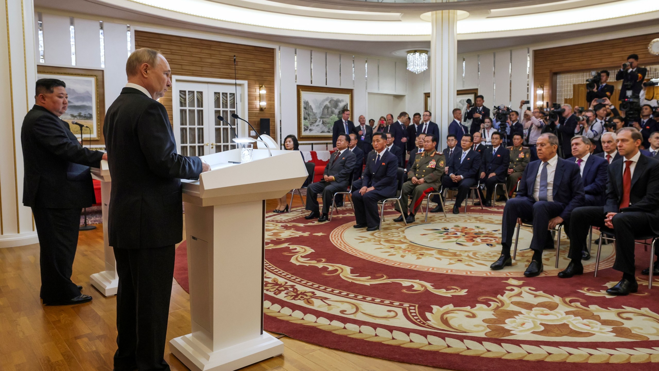 Russian President Vladimir Putin, foreground, and North Korea's leader Kim Jong Un, left, speak to the media after their talks in Pyongyang, North Korea, on Wednesday, June 19, 2024. (Gavriil Grigorov, Sputnik, Kremlin Pool Photo via AP)