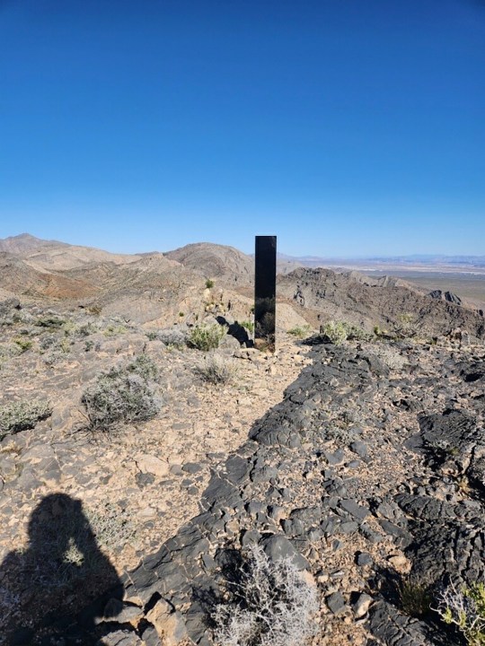 This photo provided by Las Vegas Metropolitan Police Department shows a monolith near Gass Peak, Nevada on Sunday, June 16, 2024. Jutting out of the rocks on a remote mountain peak near Las Vegas, the glimmering rectangular prism's reflective surface imitates the vast desert landscape surrounding the mountain peak where it has been erected. (Las Vegas Metropolitan Police Department via AP)